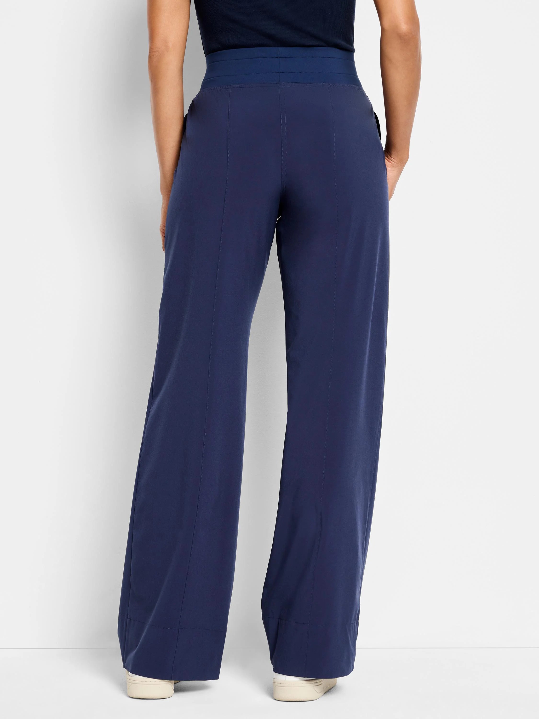 Here's alt text under 125 characters:
Navy blue wide-leg pants; elastic waistband, straight seams visible from back.