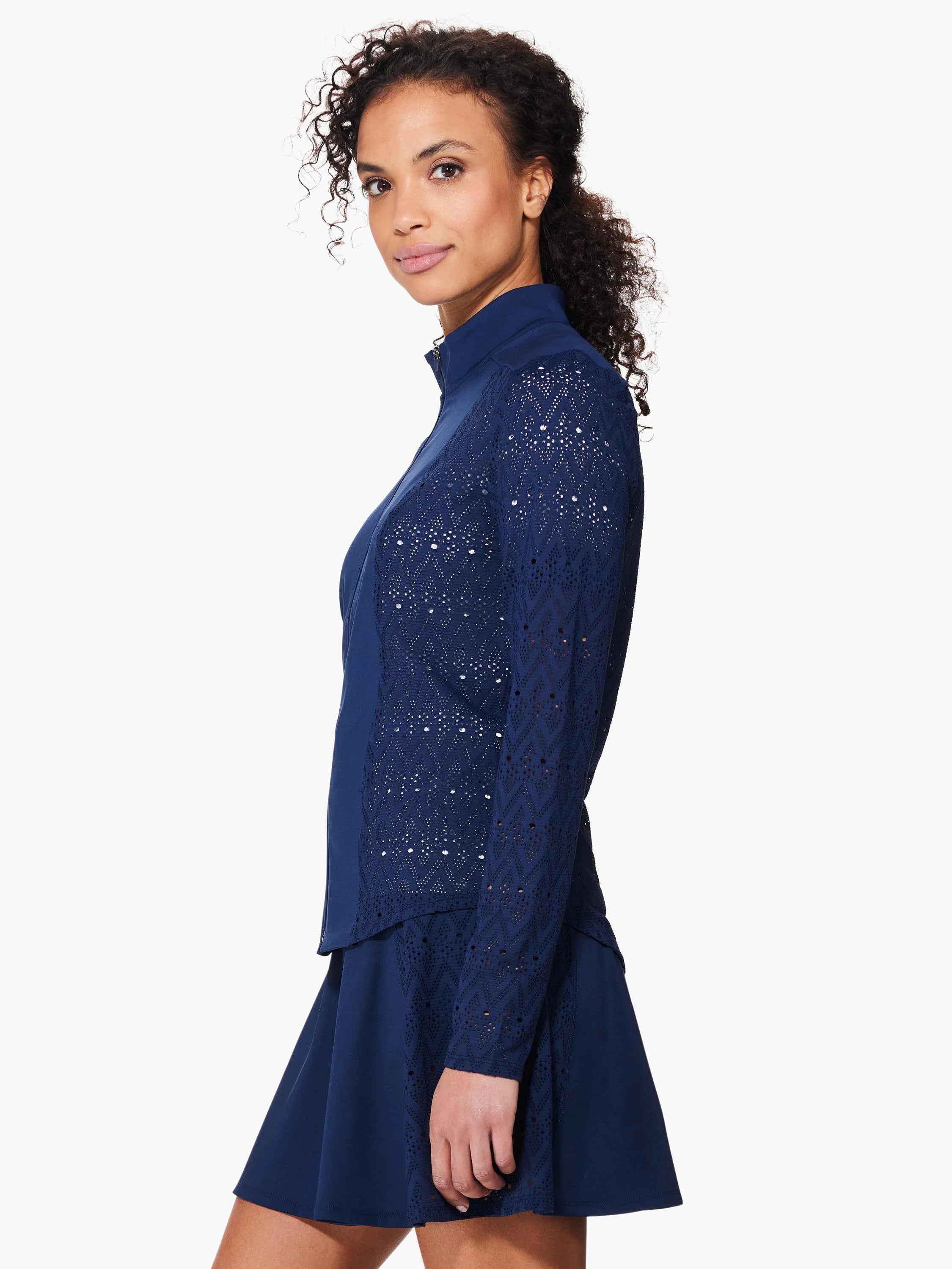 Navy blue jacket with long sleeves; sleeves and sides feature a geometric, eyelet lace pattern. Zip front.