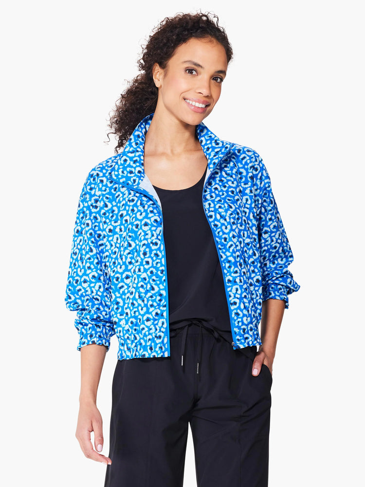 Blue jacket with a white and dark-blue leopard print. Zipper front. Cropped length.