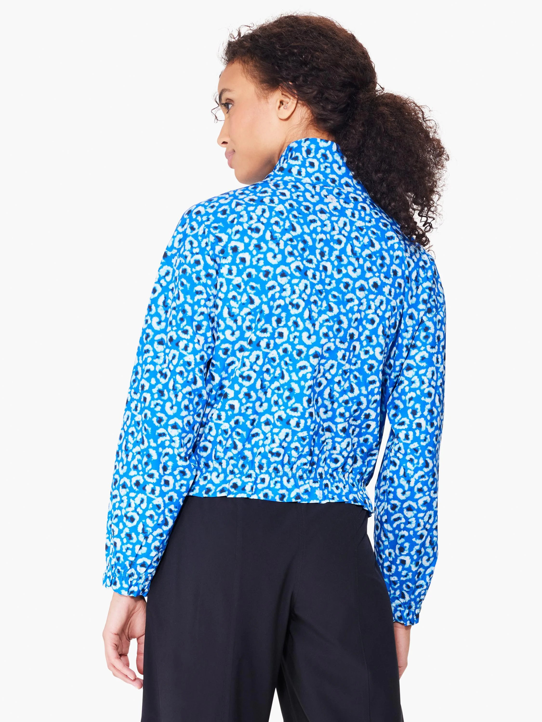 Here's alt text for the image, aiming for under 125 characters:
Blue jacket with white leopard print. Long sleeves,...