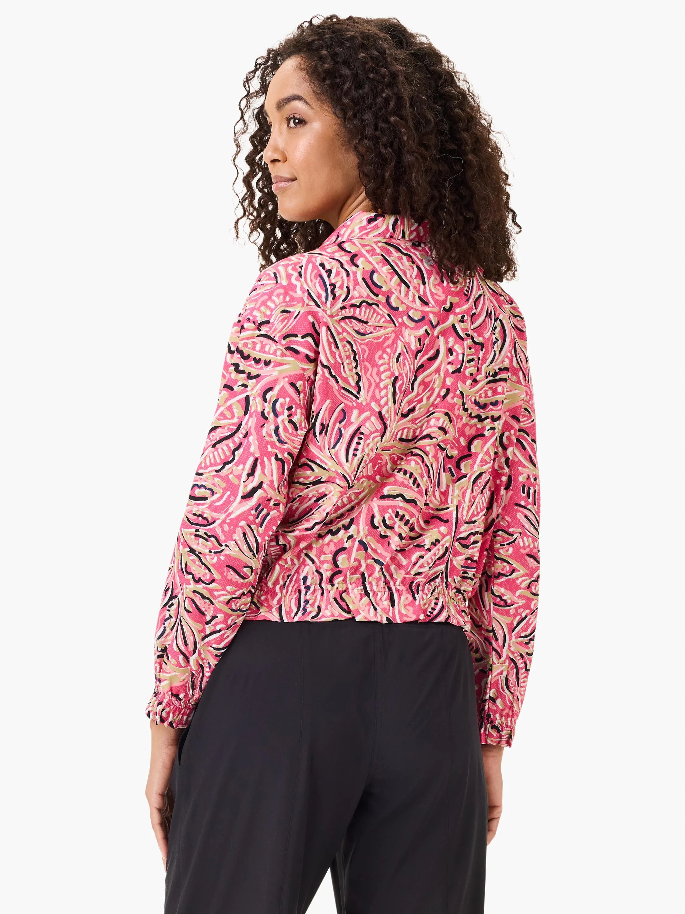 Pink jacket with a floral pattern in beige, black, and dark pink. Long sleeves with elastic cuffs.