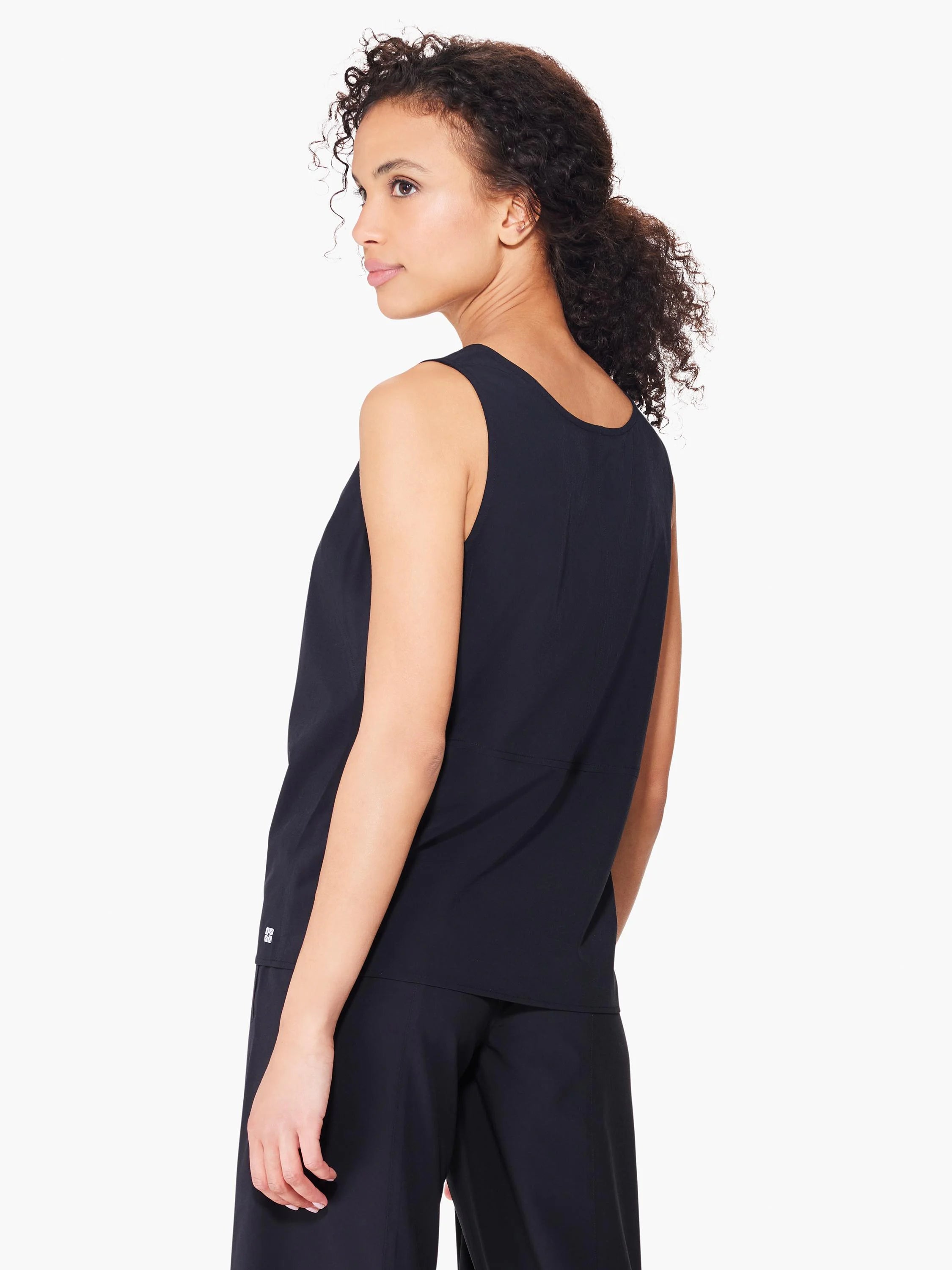 Black sleeveless tank top, seamed detail at sides. Small logo near hem.
