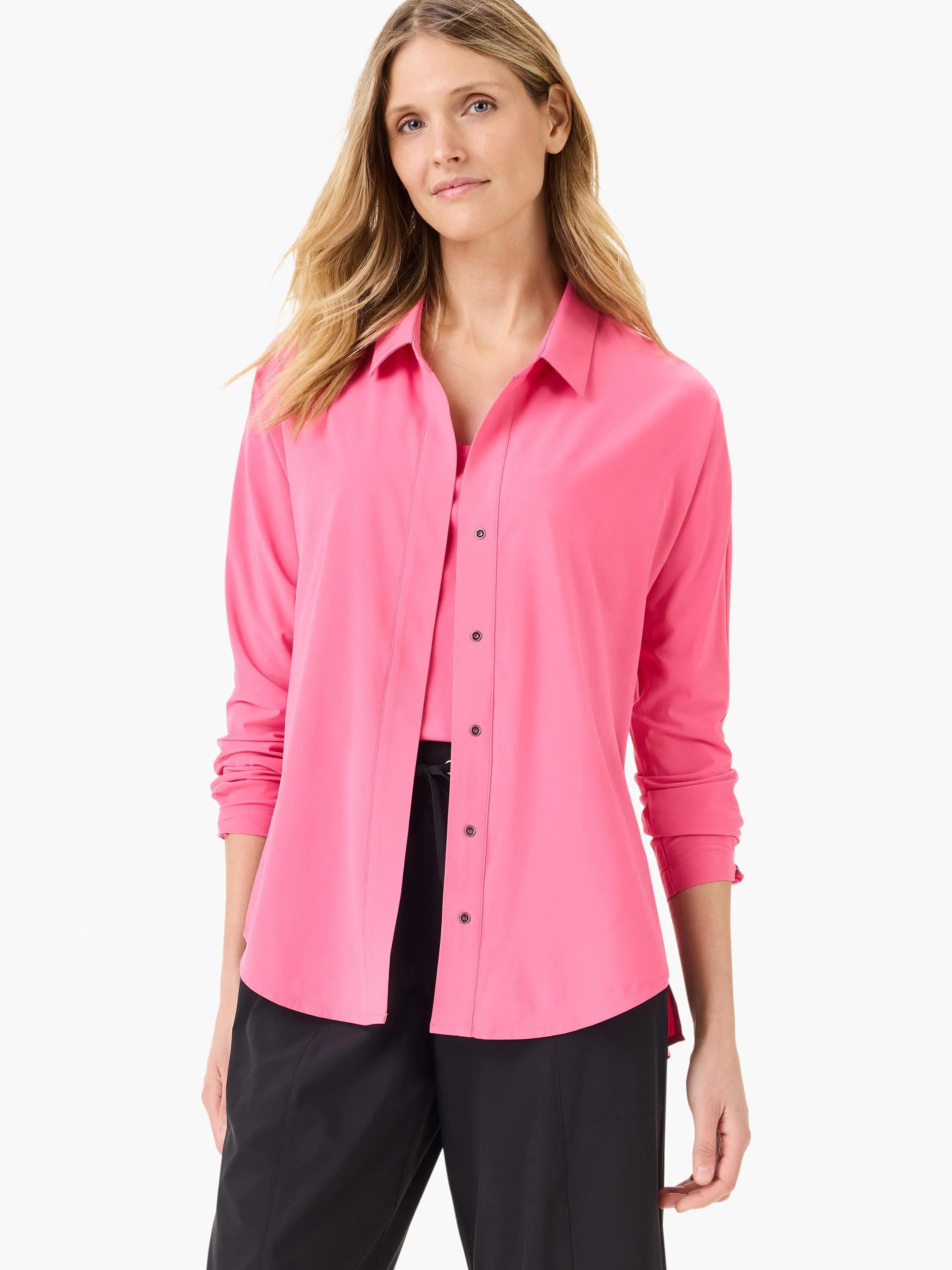 Bright pink collared shirt with dark snap buttons and rolled-up long sleeves.
