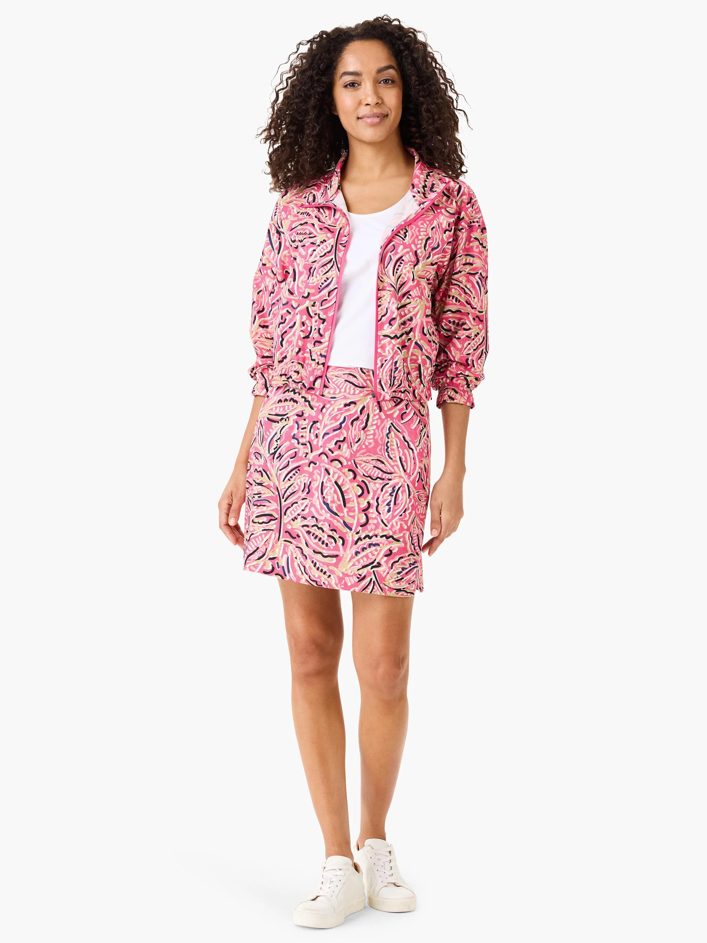 Pink floral skort with dark pink, beige, and navy print.  Model wears matching jacket.