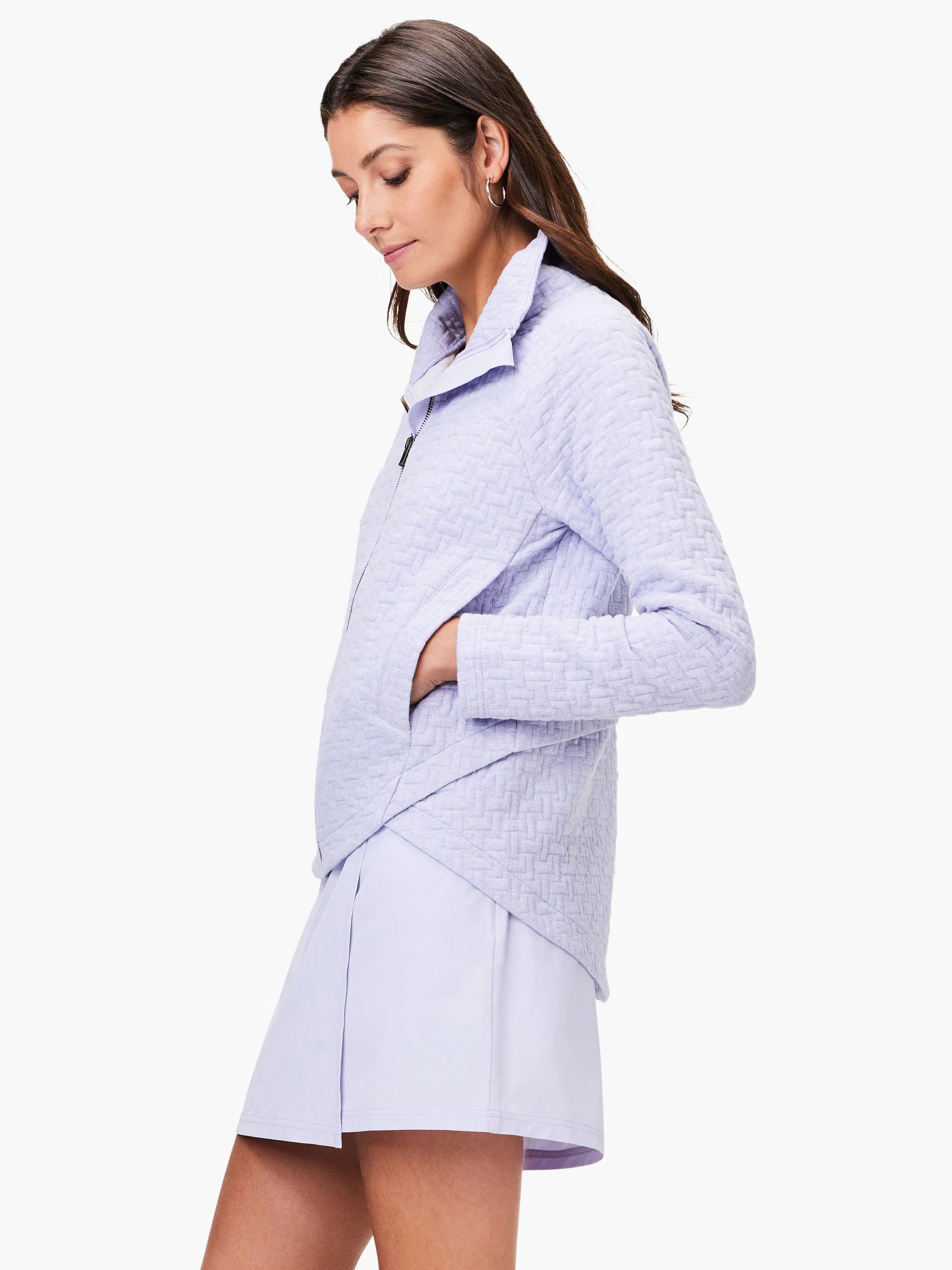 Lavender quilted jacket, zip front, long sleeves, and pockets. A textured, woven pattern.