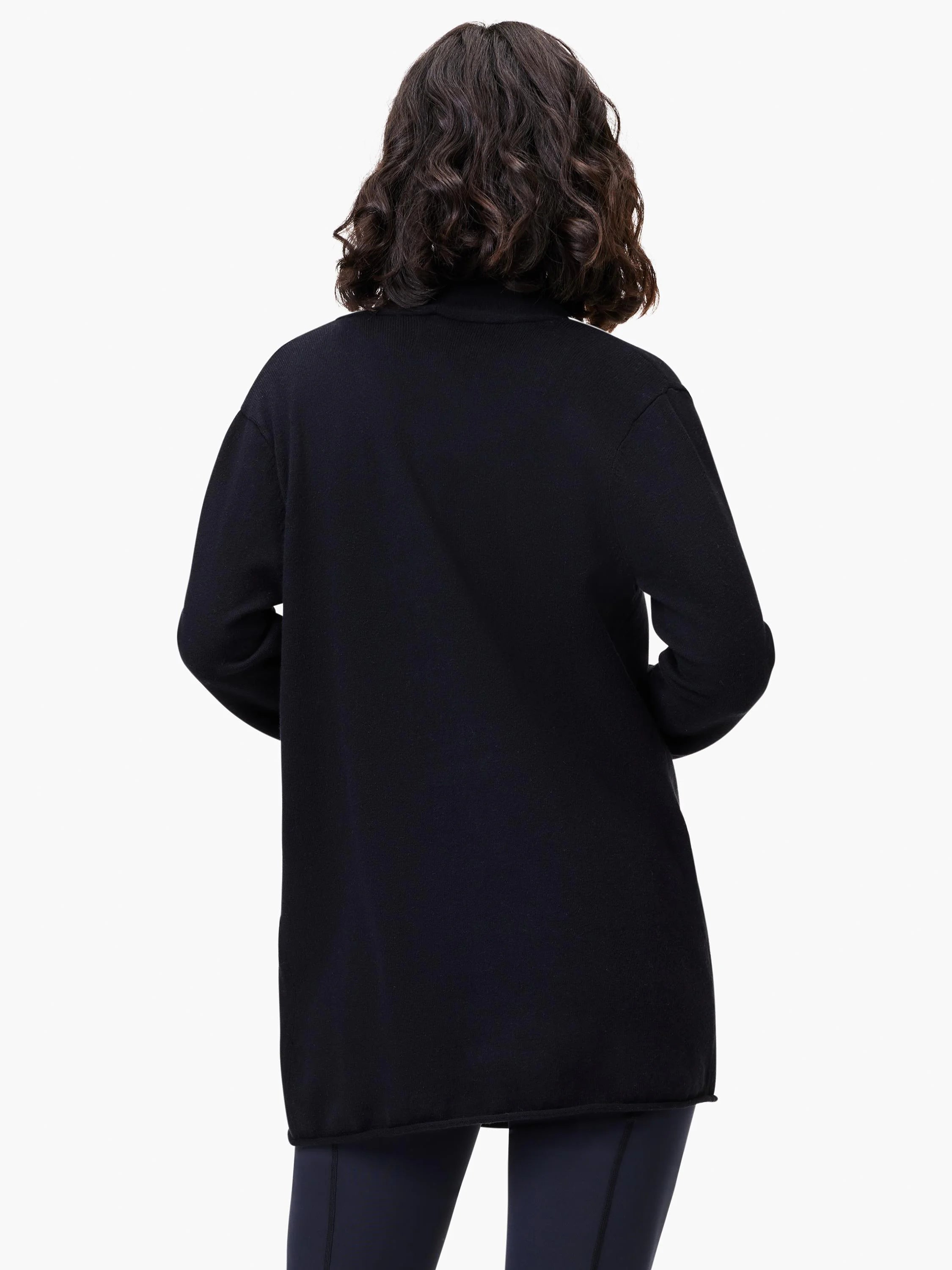 Black open-front cardigan, long sleeves, hip-length. Model shown wearing black bottoms.