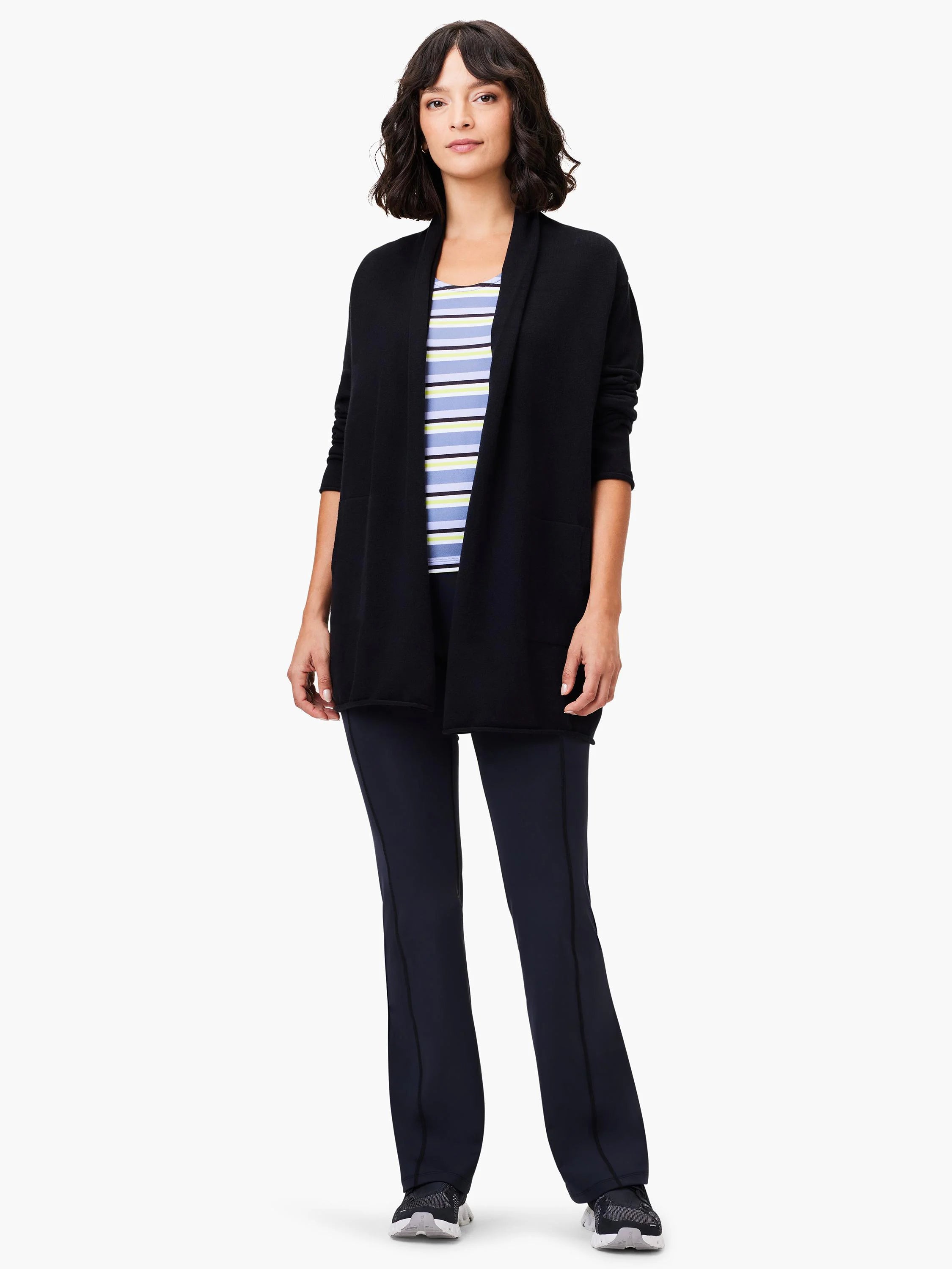 Black open-front cardigan, long sleeves. Model wears it over a light blue and yellow striped top and dark pants.