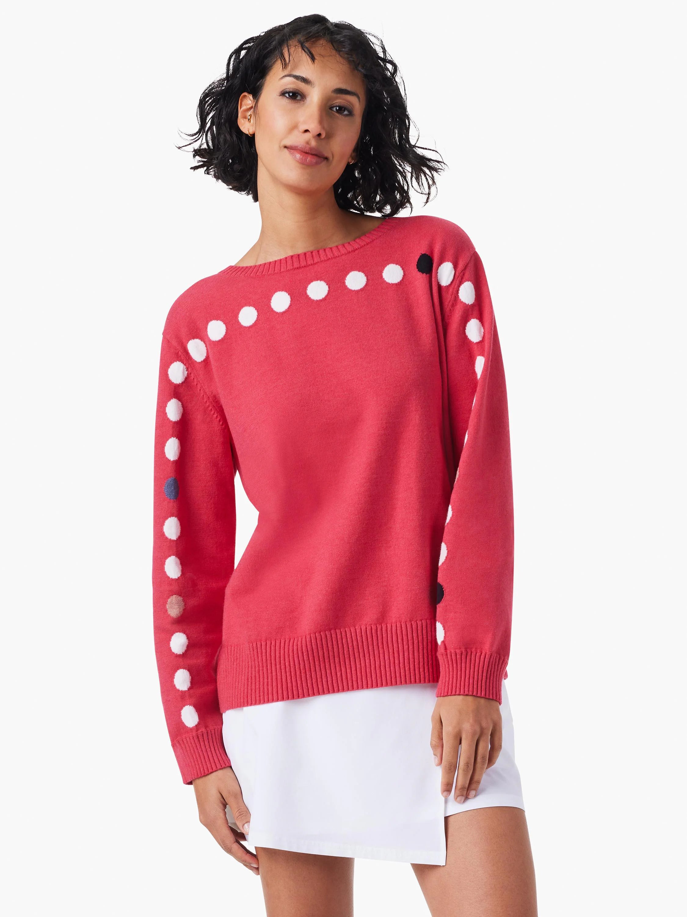 Pink sweater with white, black, and other small colored dots along the shoulders and sleeves. Long sleeves, ribbed hem.