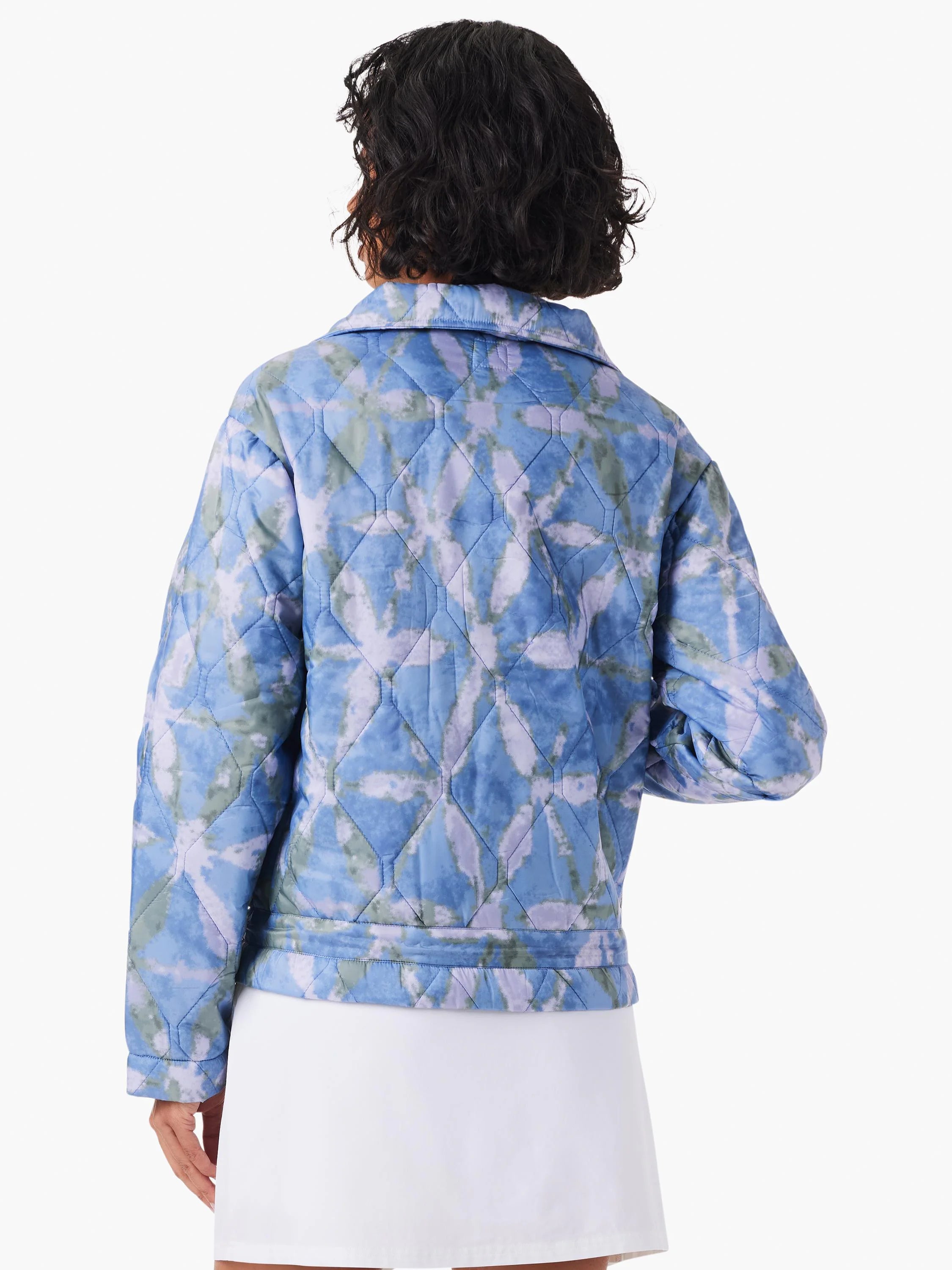 Back view of a quilted puffer jacket with blue, purple, and green mottled pattern and diamond stitching.