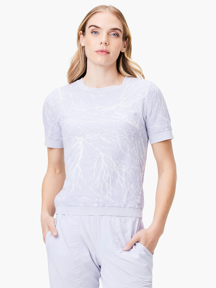 Light lavender short-sleeved sweater tee with a textured, lighter lavender leaf pattern. Crew neck.