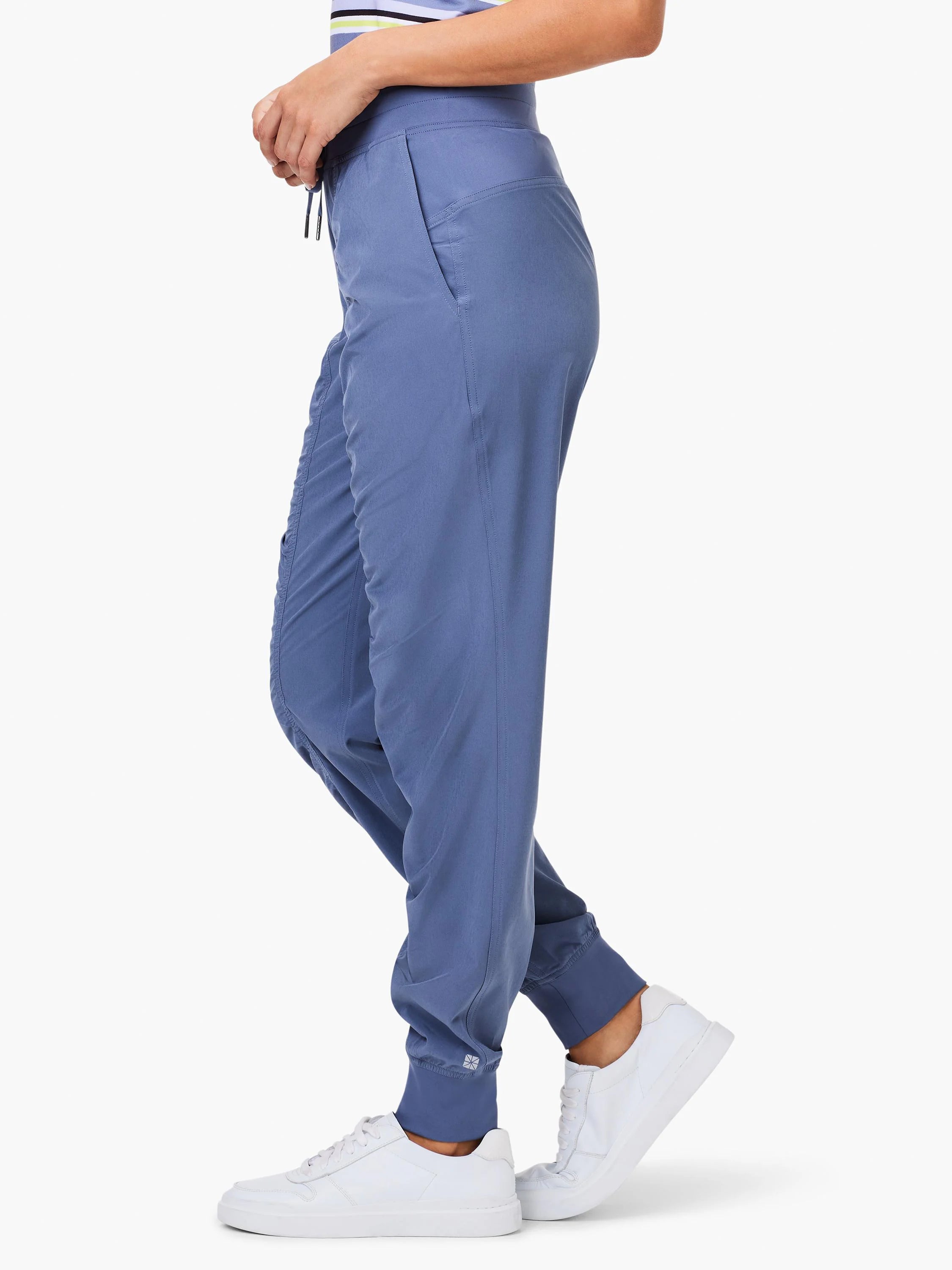Periwinkle joggers with drawstring waist, side pockets, ruched legs, and elastic cuffed ankles with a white logo.