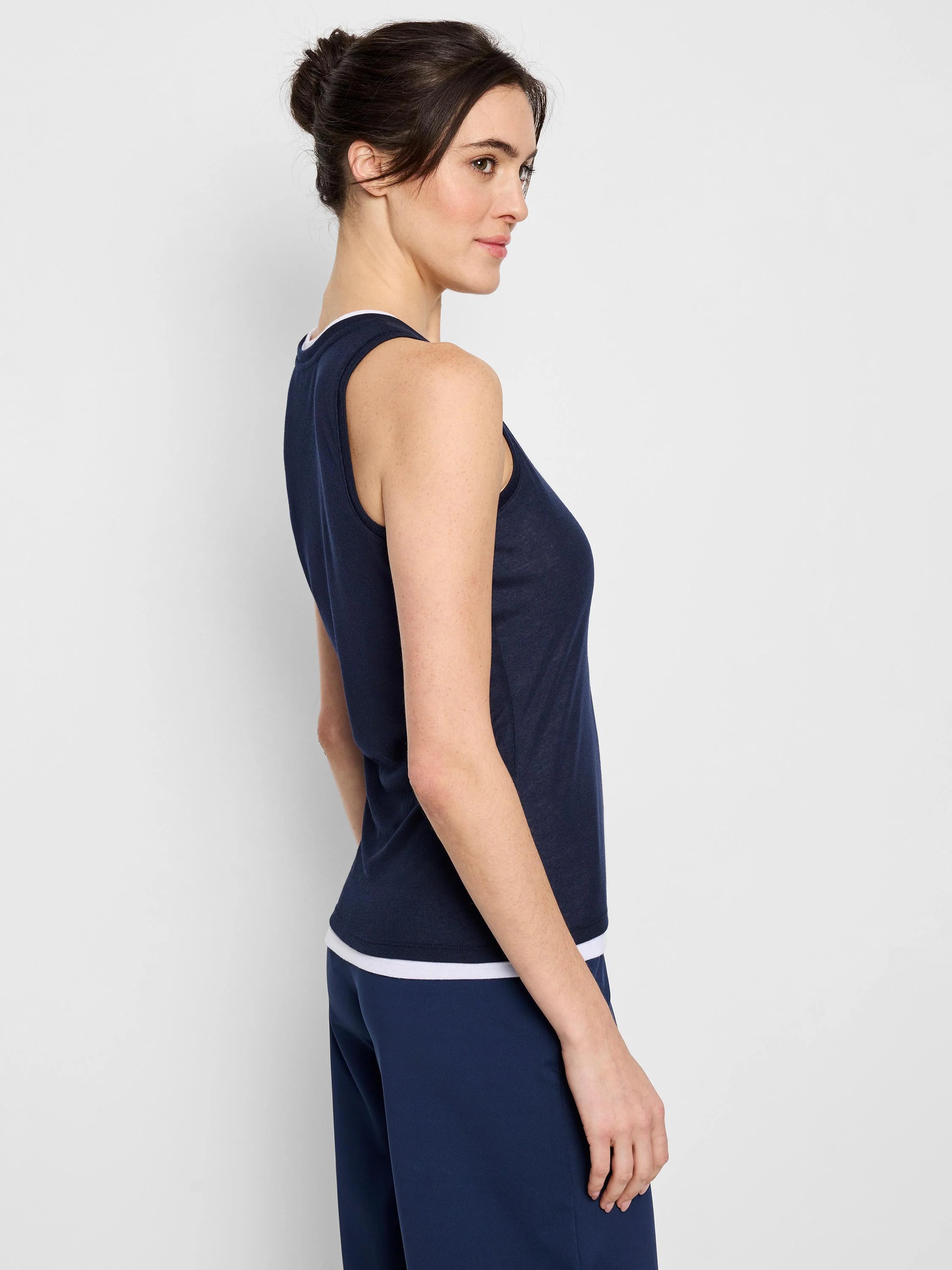 Navy blue sleeveless tank top; double layer with white trim at hem.