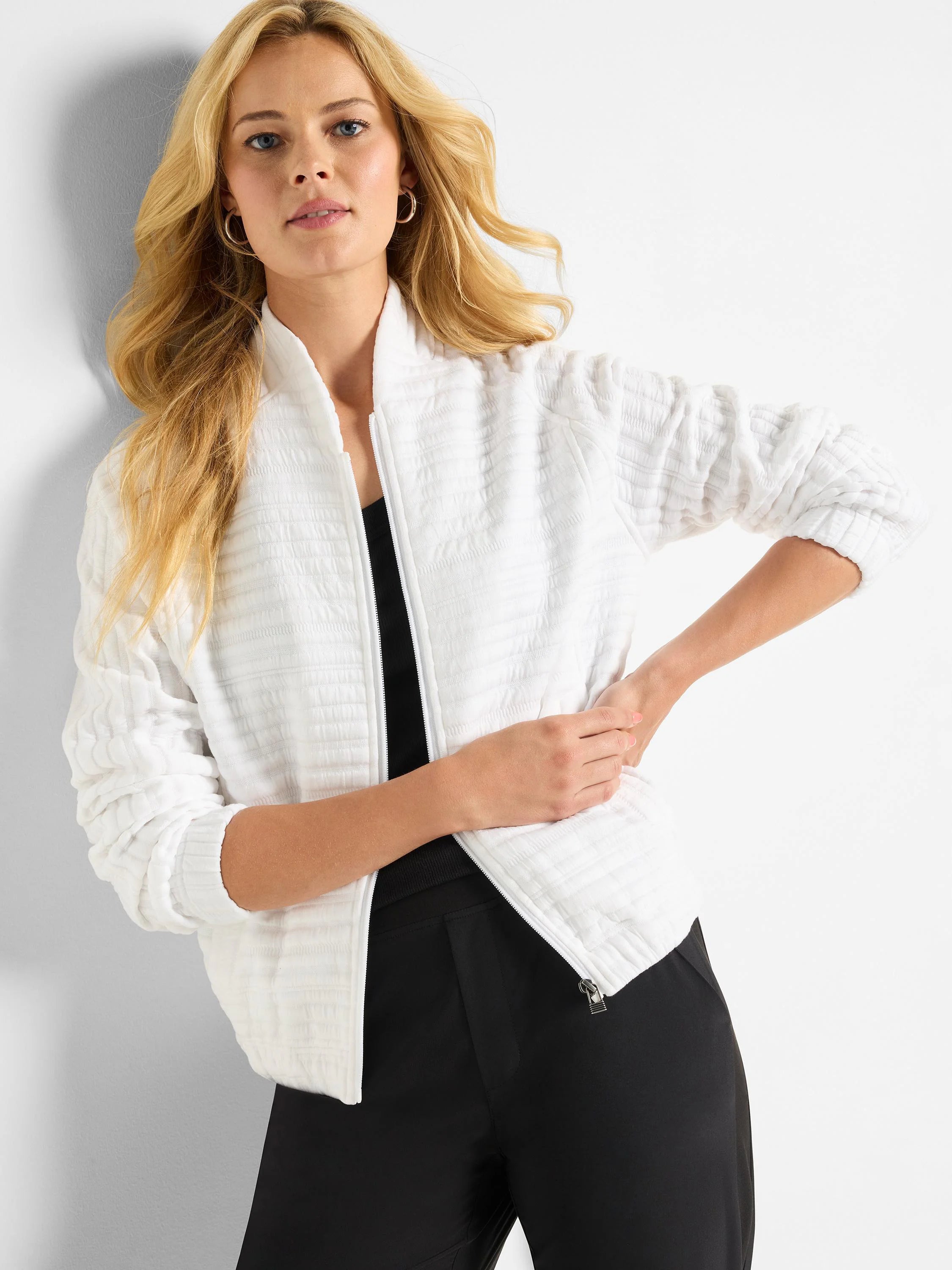 White zip-front jacket with textured, horizontal stripes. Long sleeves.