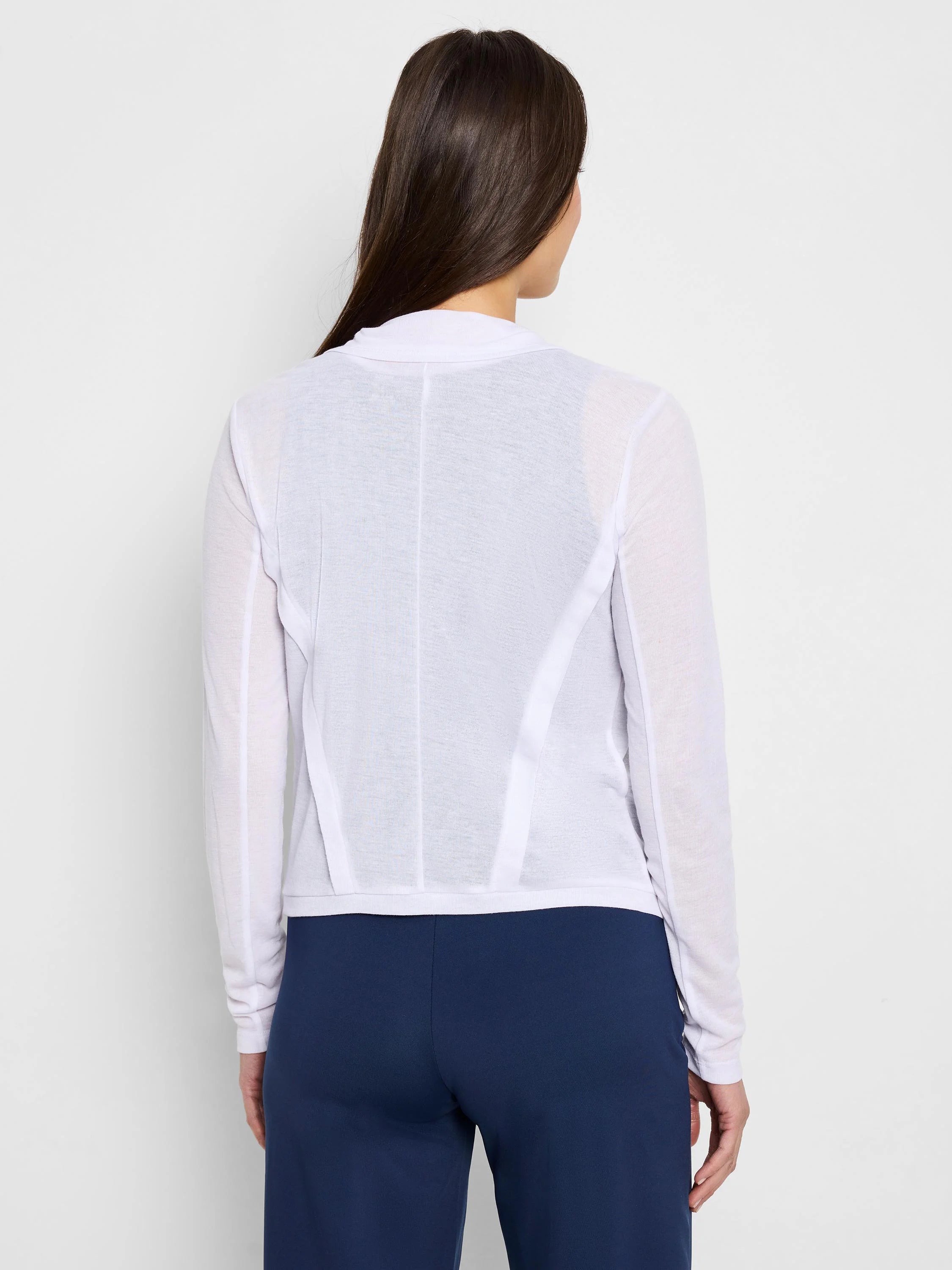 White gauzy cardigan, long sleeves, snap front (unfastened), seamed detailing at back.