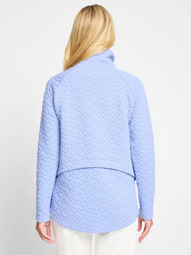 Light blue quilted jacket, long sleeves, high neck. Diamond-shaped quilting pattern.