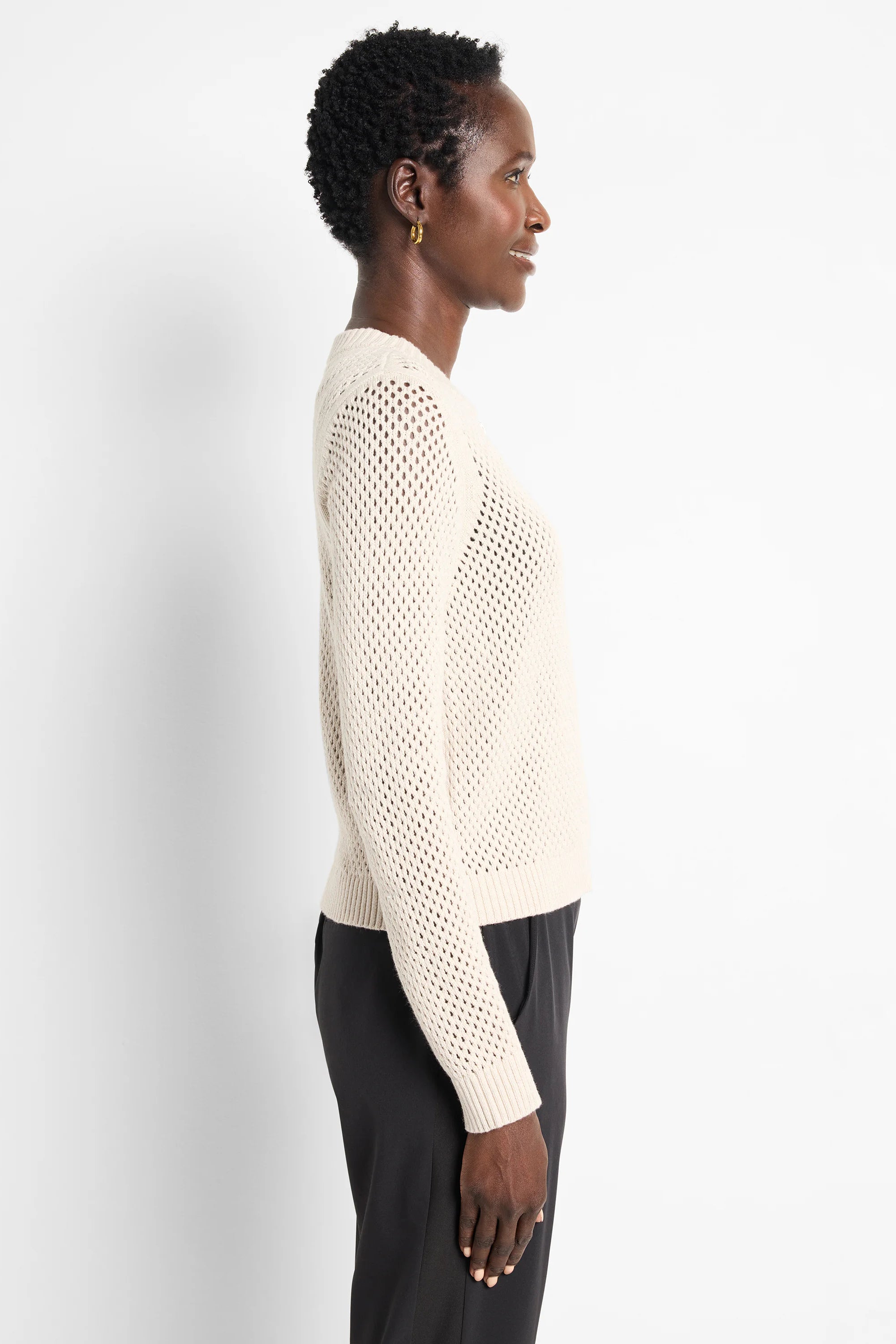 Off-white zip-front mesh cardigan. Long sleeves, open knit.