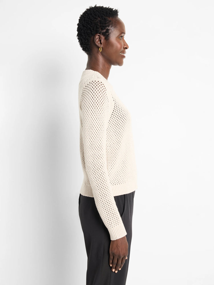 Off-white zip-front mesh cardigan. Long sleeves, open knit.
