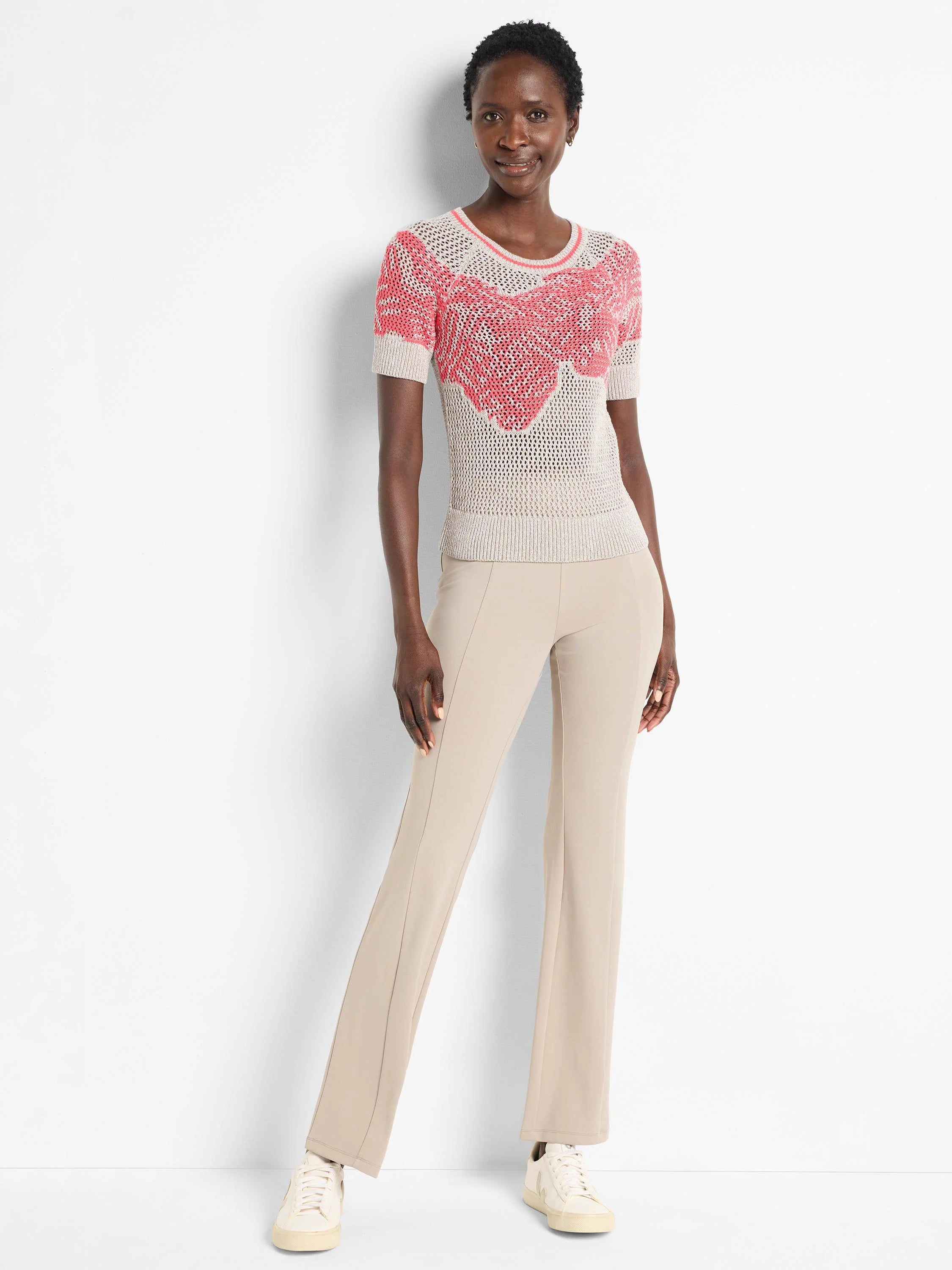 Short-sleeved beige sweater with coral mesh detail. The sweater has a round neckline.