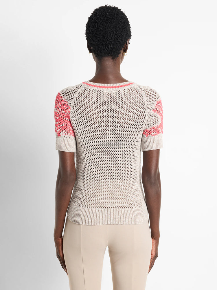 Beige mesh short-sleeved sweater with coral accents at neckline and sleeves. Back view.