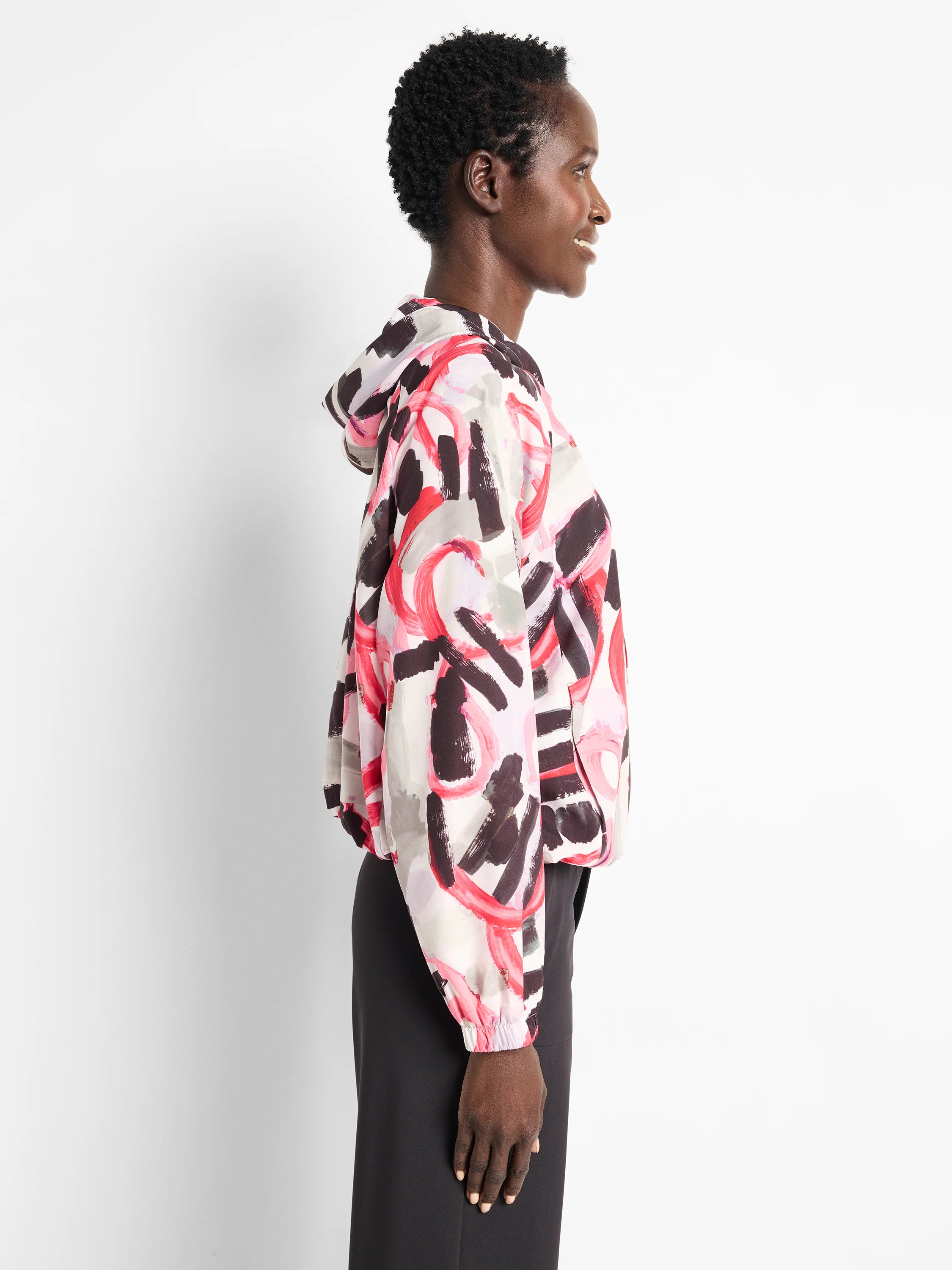 Here's alt text for the image, under 125 characters:
"Hooded windbreaker. Off-white base with abstract red, pink, and...