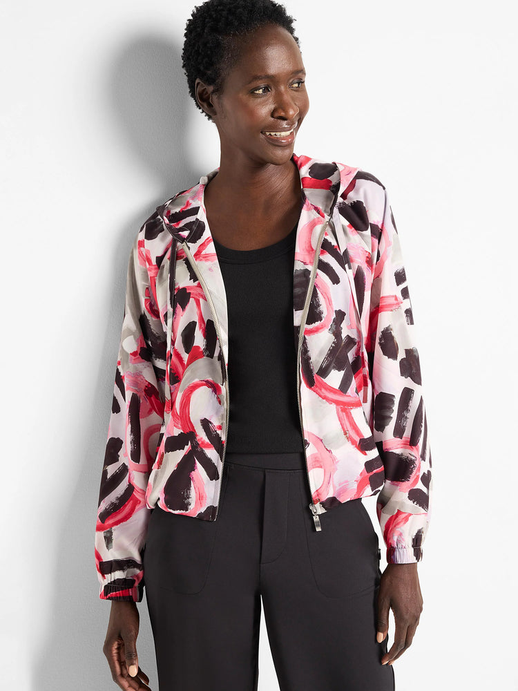 Hooded windbreaker with an abstract print in pink, black, and gray on a light background. Zipper closure.