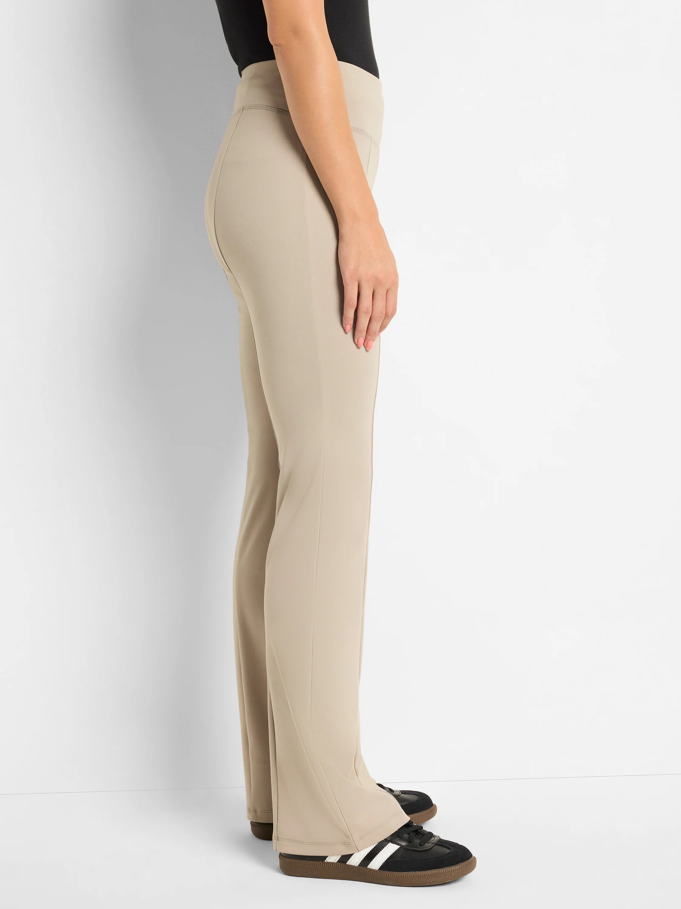 Beige bootcut pants, shown on a model. Slight flare at the bottom.