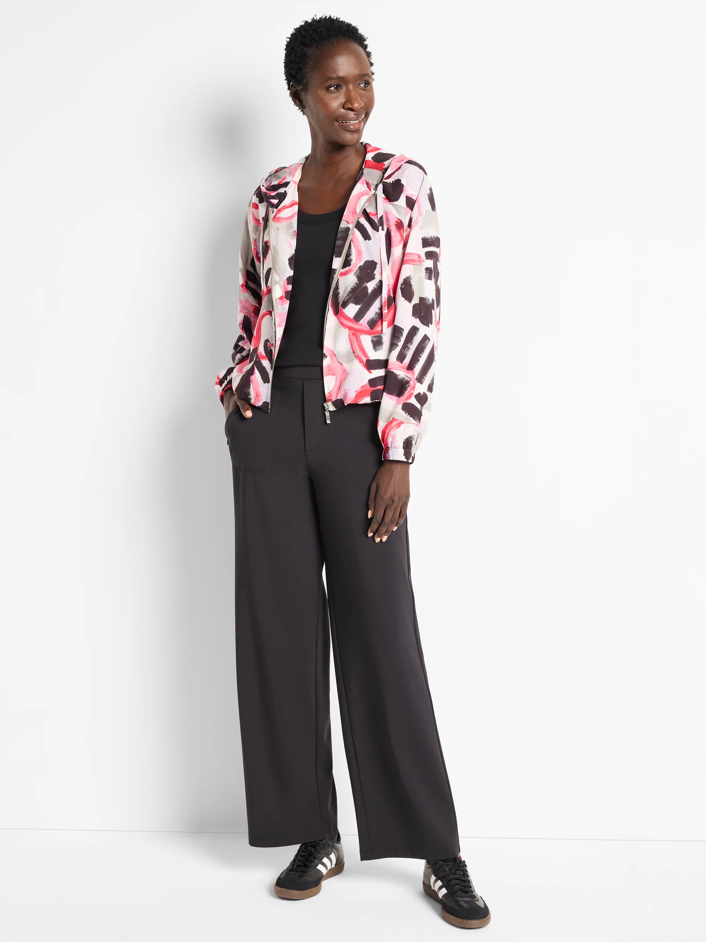 Black wide-leg pants; model wears a pink, black, and gray patterned jacket.
