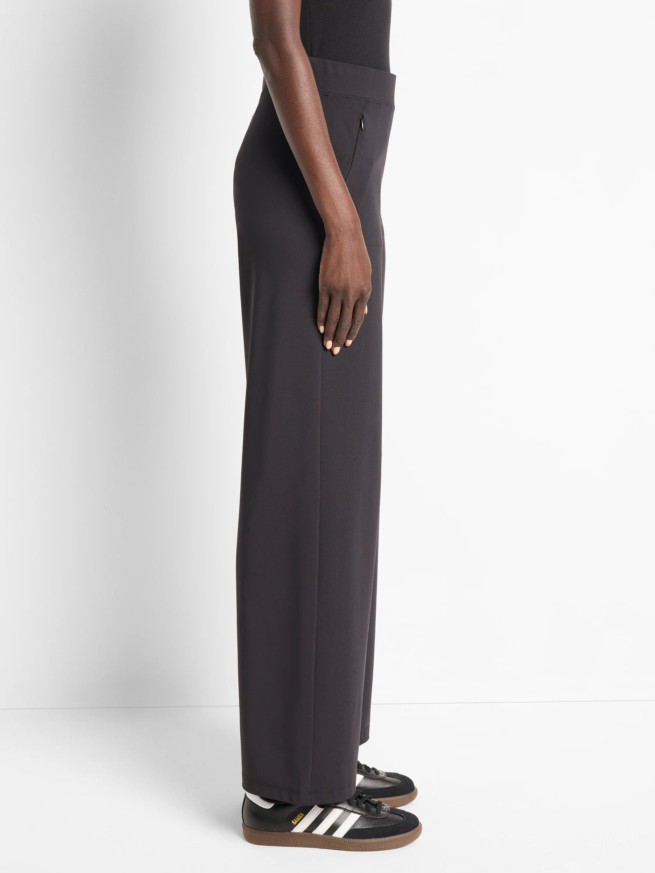 Dark gray wide-leg pants; side zip detail. Shown on model.