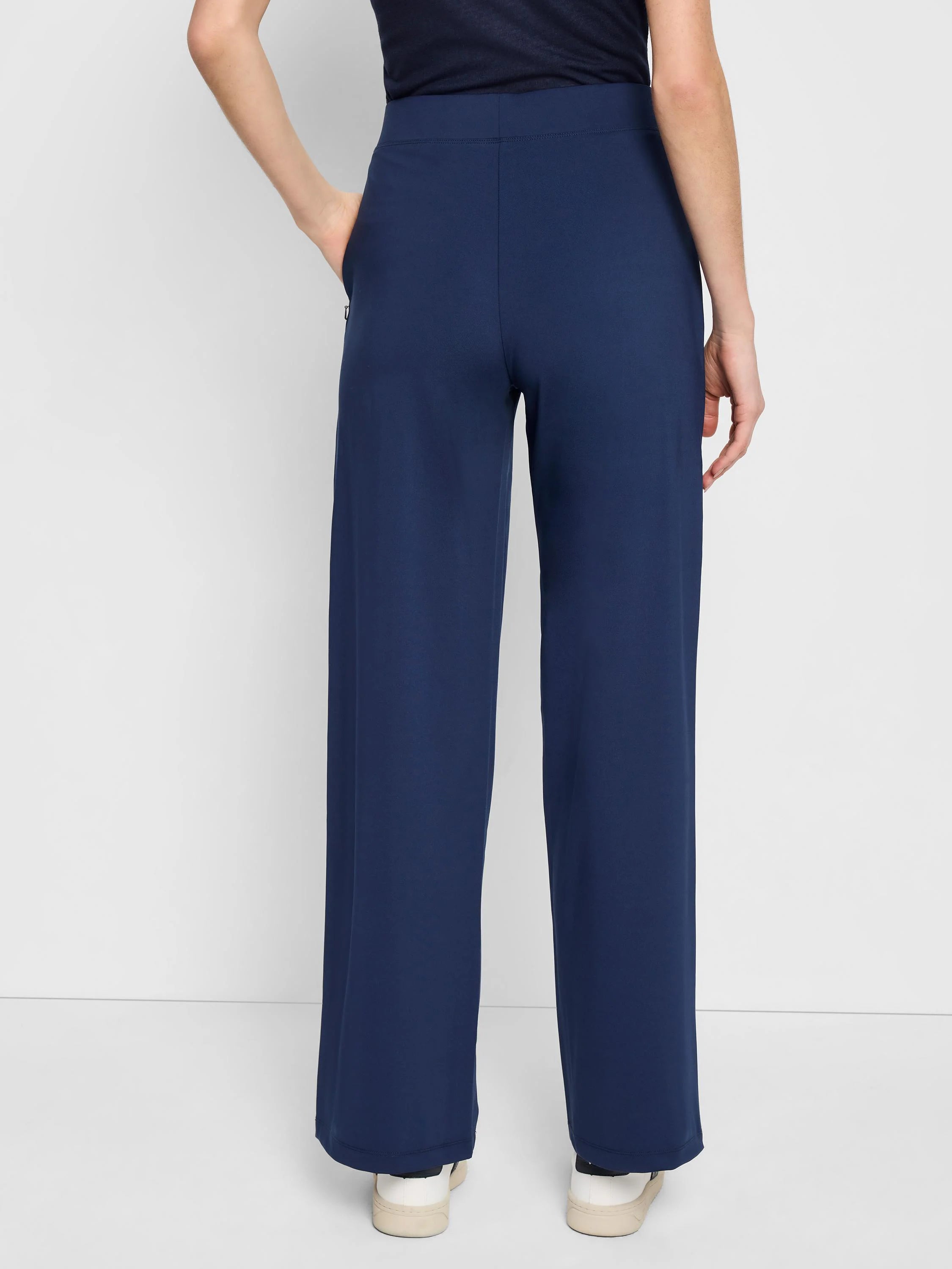 Here's alt text for the image, under 125 characters:
"Navy blue wide-leg pants, pull-on style, seen from behind. The...
