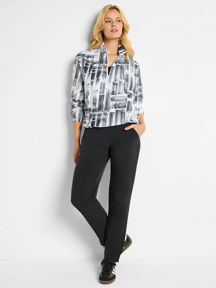 Black and white abstract print popover, half-zip. Paired with black straight-leg pants.