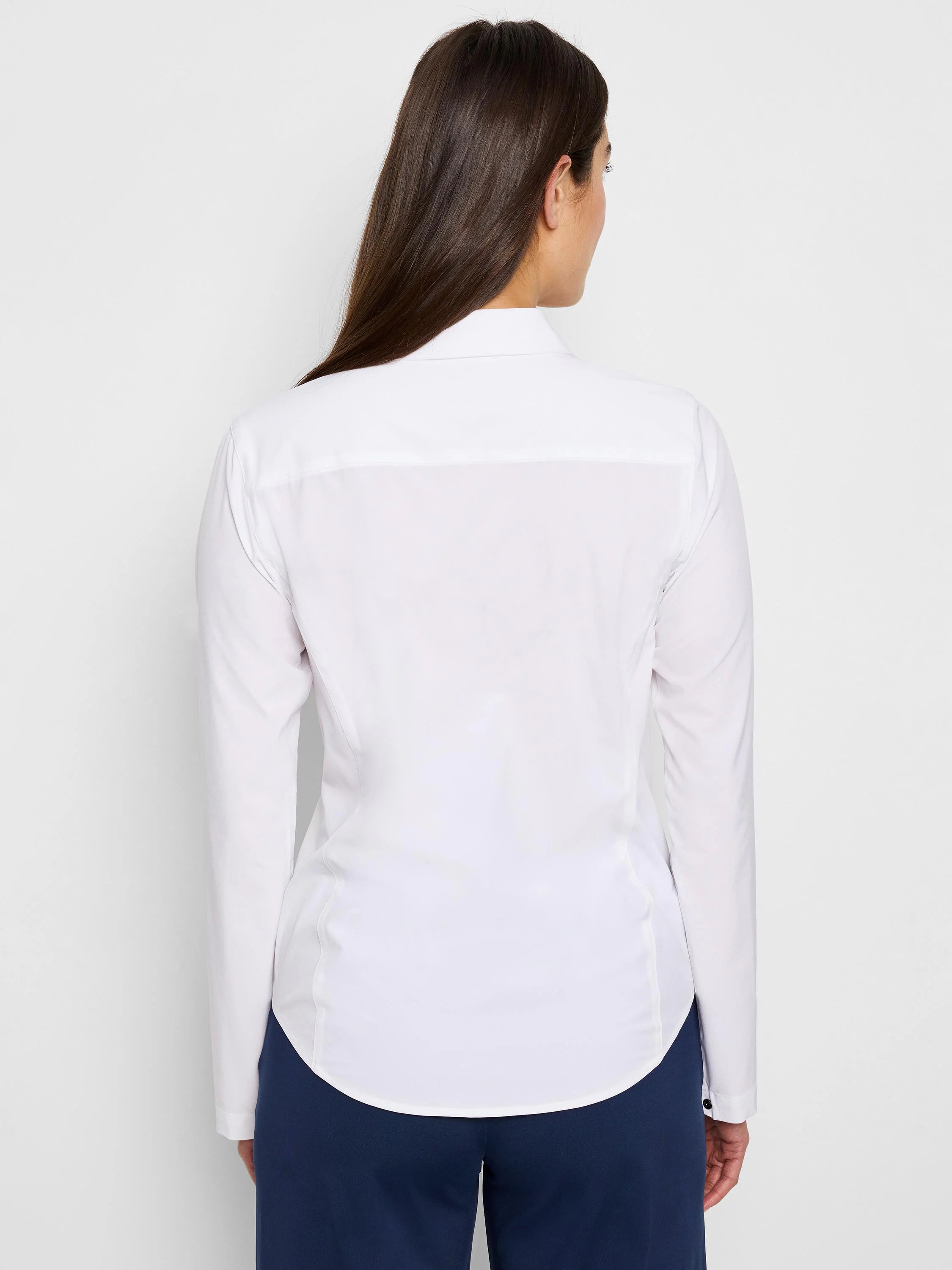 White long-sleeve collared shirt, viewed from the back. The shirt is fitted and has a curved hem.