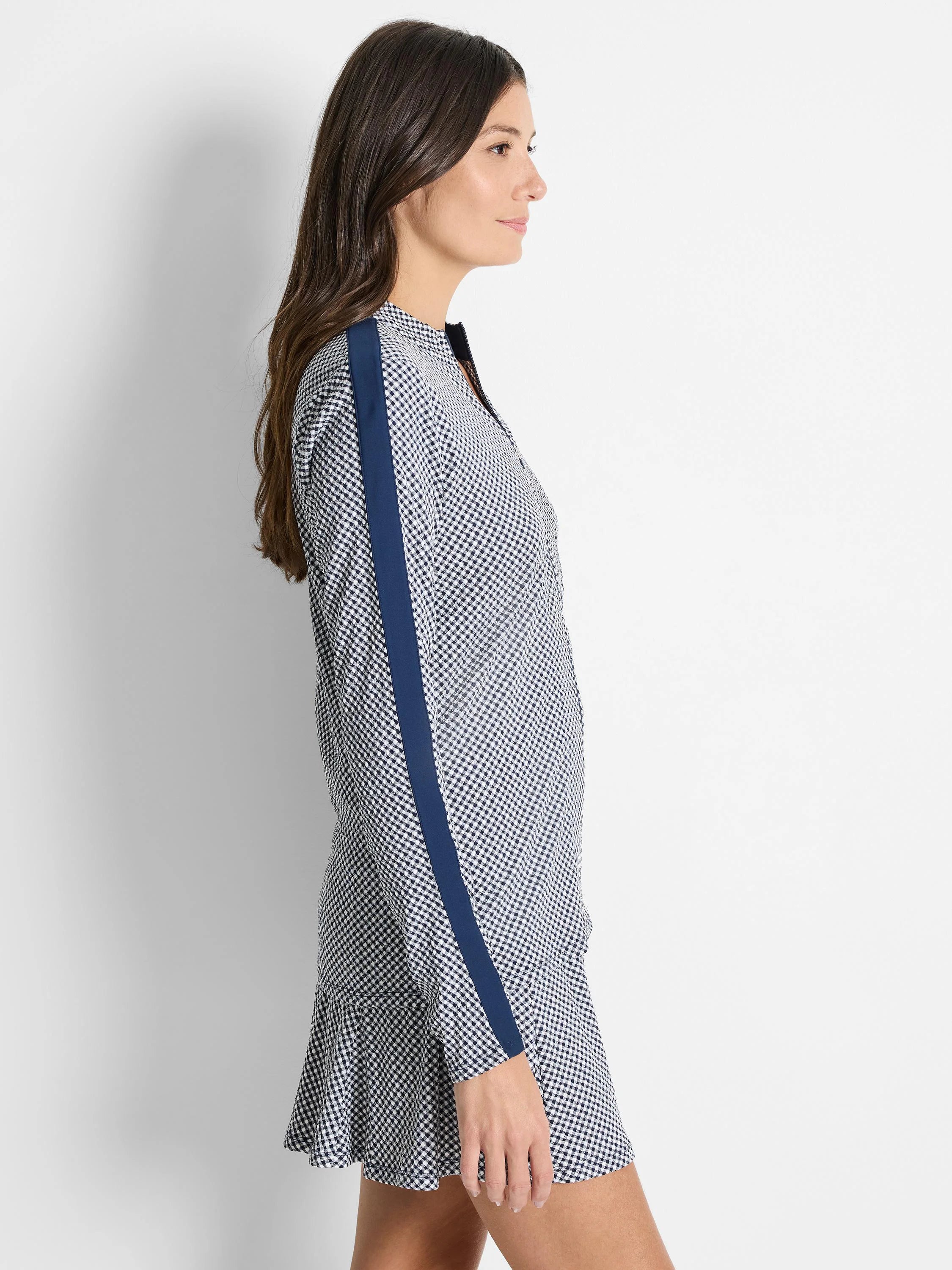 White and navy blue gingham print jacket with a navy blue stripe down the sleeves and a ruffled hem.