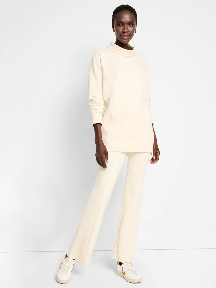Off-white scuba tunic with funnel neck, long sleeves, and a kangaroo pocket. Shown with matching off-white pants.