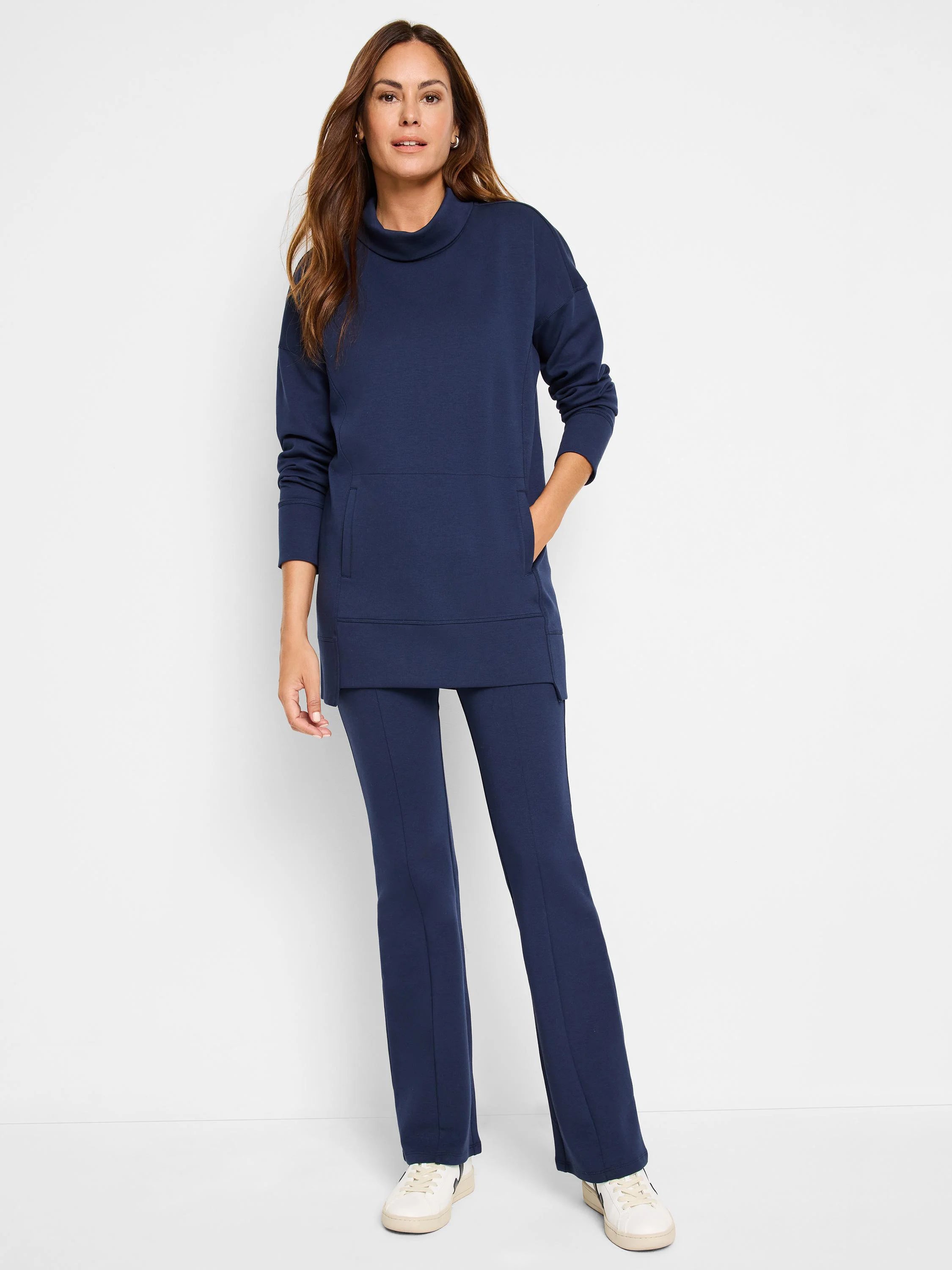 Navy blue tunic with funnel neck, long sleeves, and kangaroo pocket. Matching navy blue flared pants.