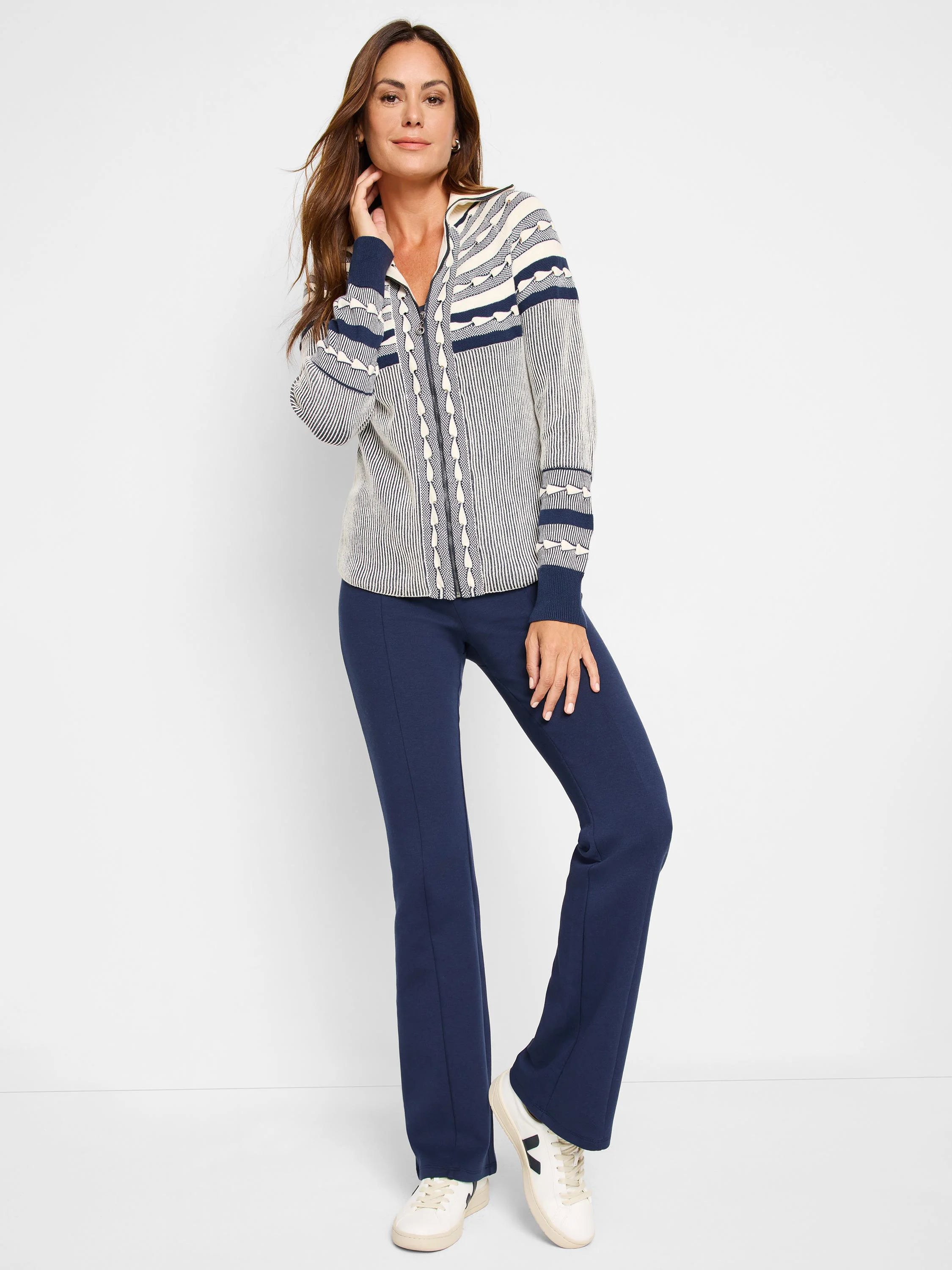 Cream zip-front cardigan with navy blue Fair Isle pattern and trim.  The cardigan has a textured knit.