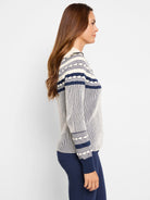 Cream zip-front cardigan with navy blue Fair Isle pattern on yoke and cuffs.  Vertical stripes throughout.