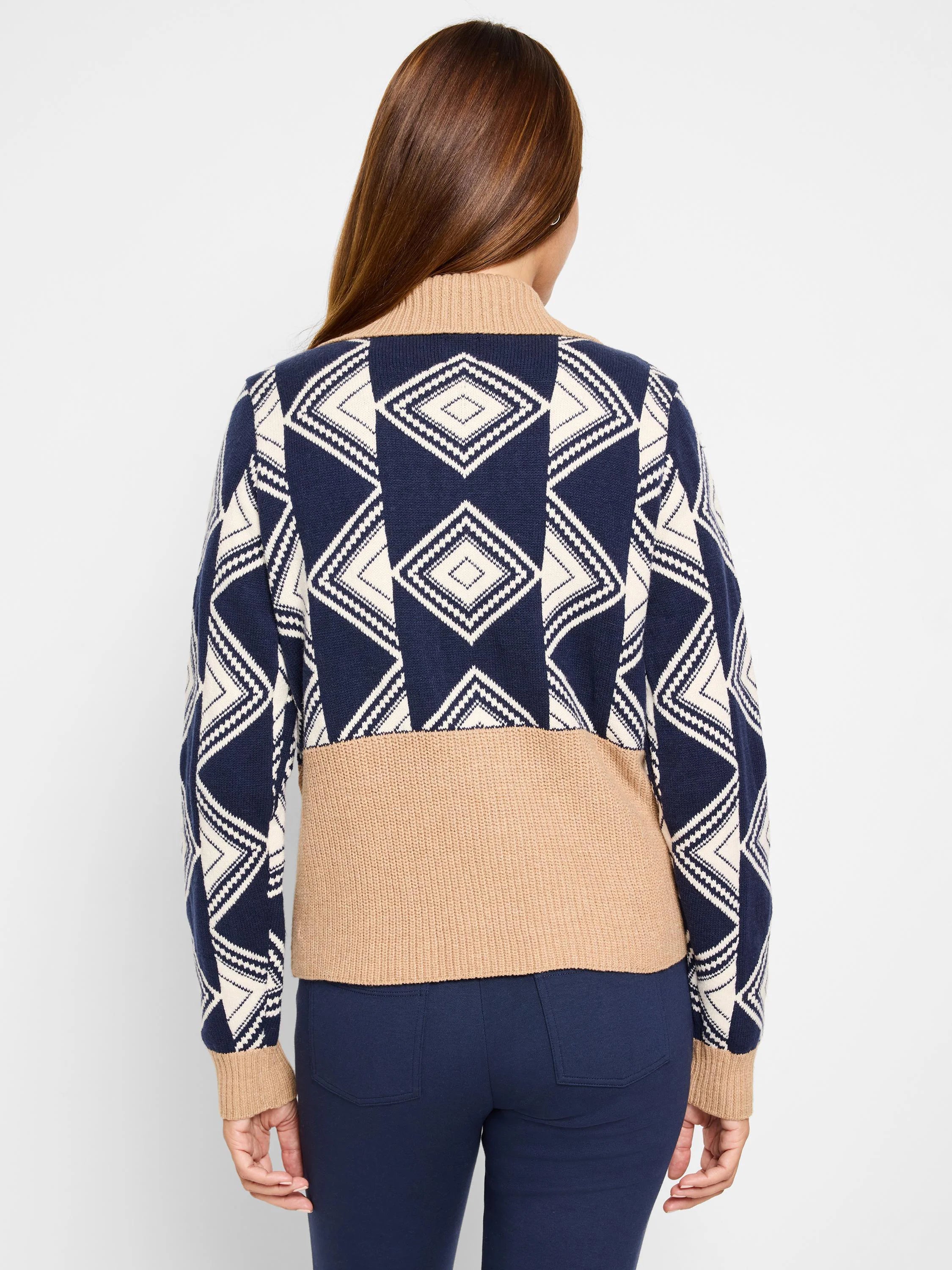 Navy blue and cream diamond pattern sweater; beige bottom band and cuffs. Half-zip neckline.