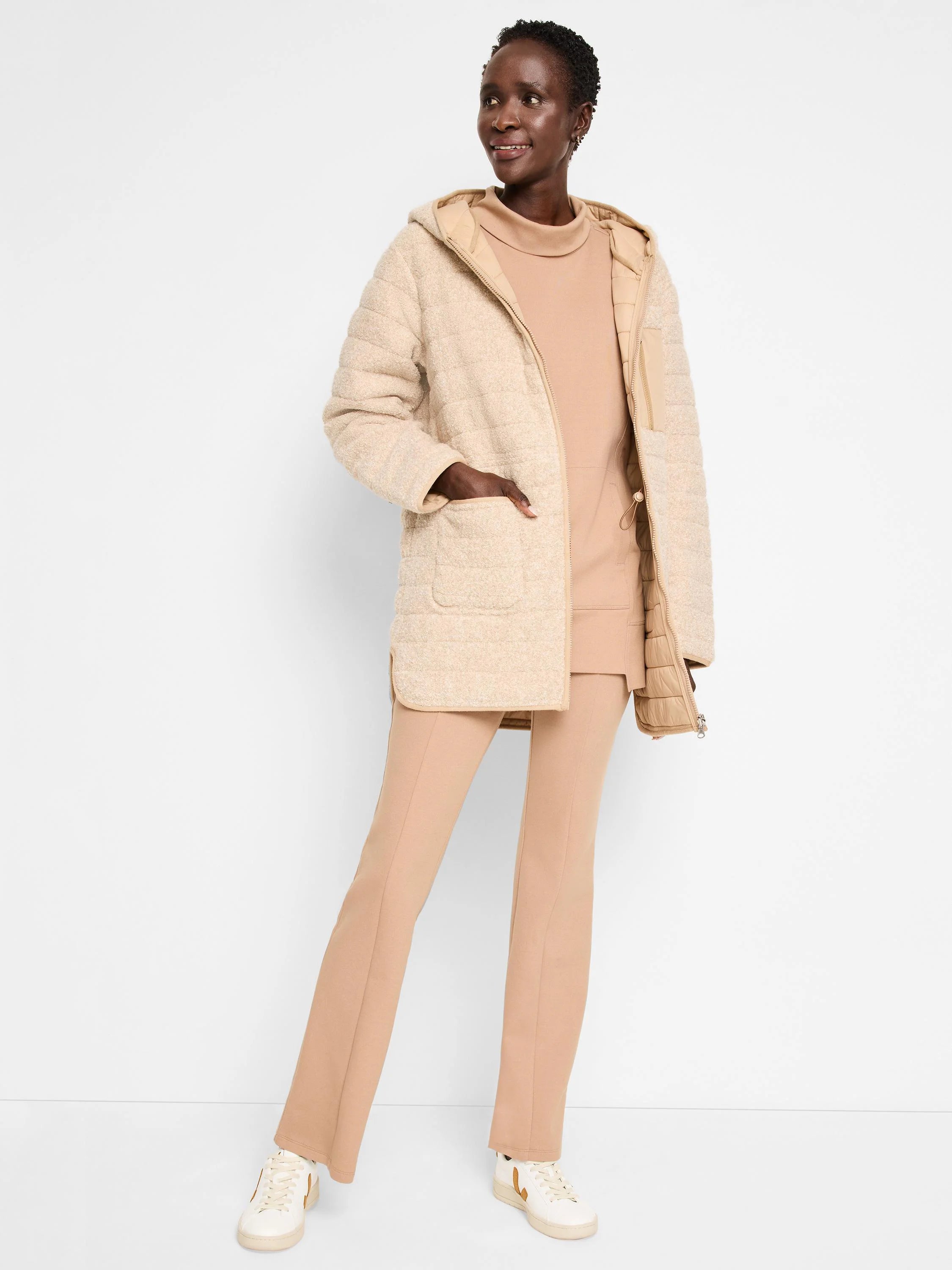 Beige hooded quilted coat, reversible. One side is textured, the other is quilted. Features pockets.