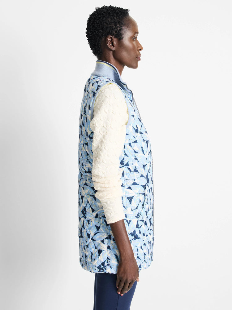 Reversible vest; light blue with dark blue floral pattern on one side. The other side is not shown. Quilted. Zipper front.