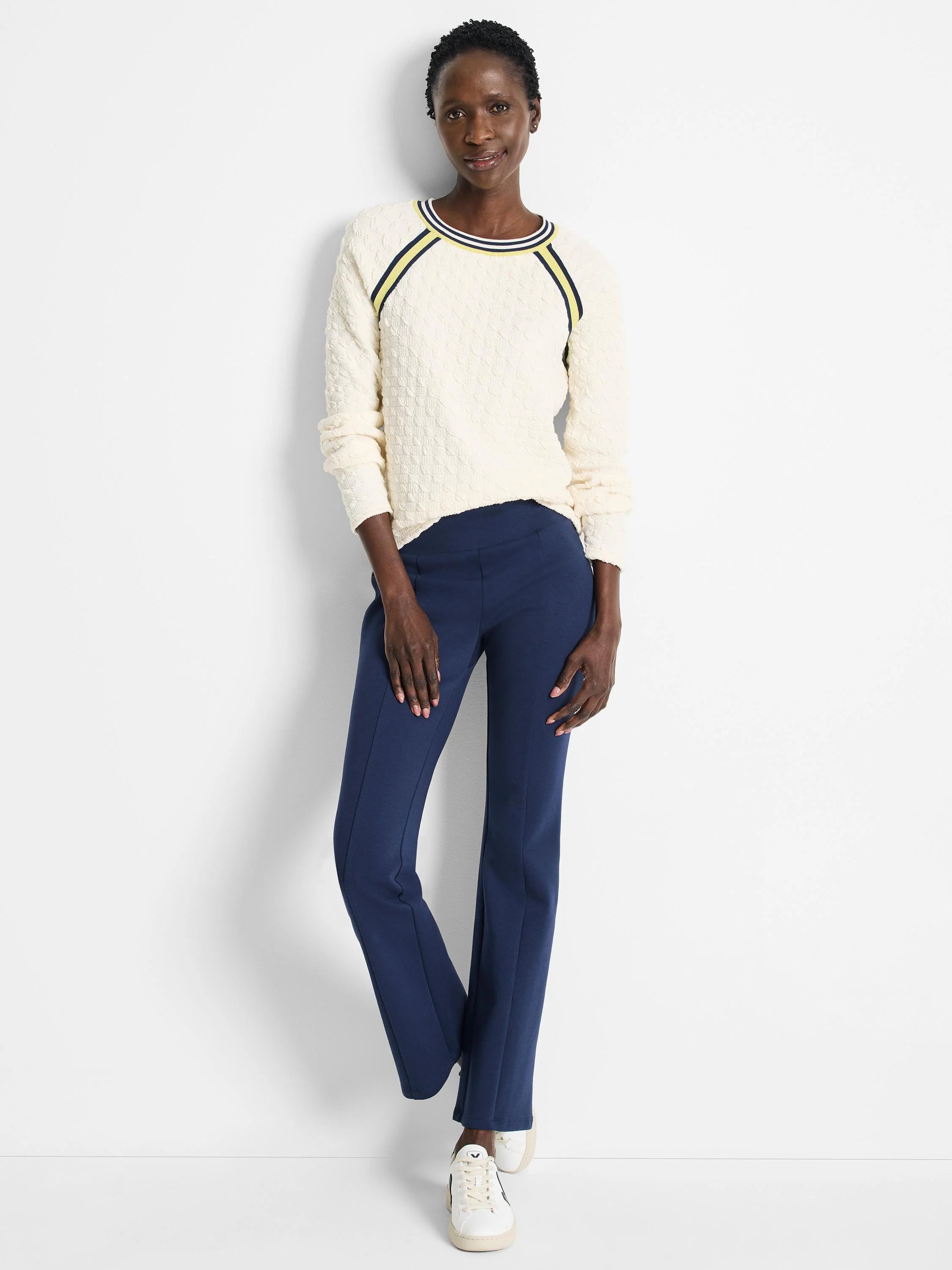 Off-white textured sweater with navy and yellow stripes at neckline.