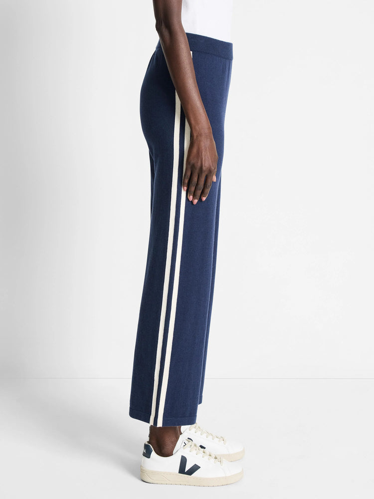 Here's alt text for the image, under 125 characters:
Navy blue wide-leg pants with off-white side stripes.