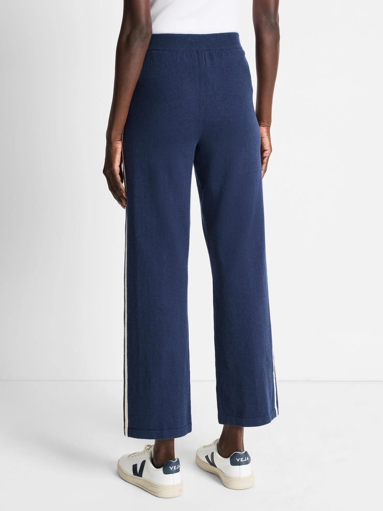 Dark navy blue wide-leg pants with off-white side stripes.
