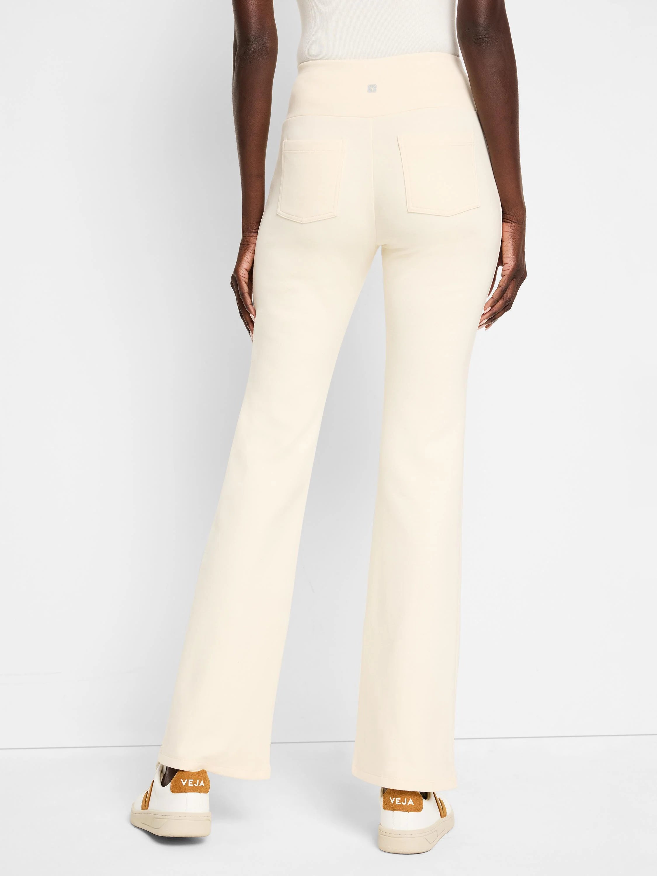 Off-white bootcut pants with back pockets. High-waisted.