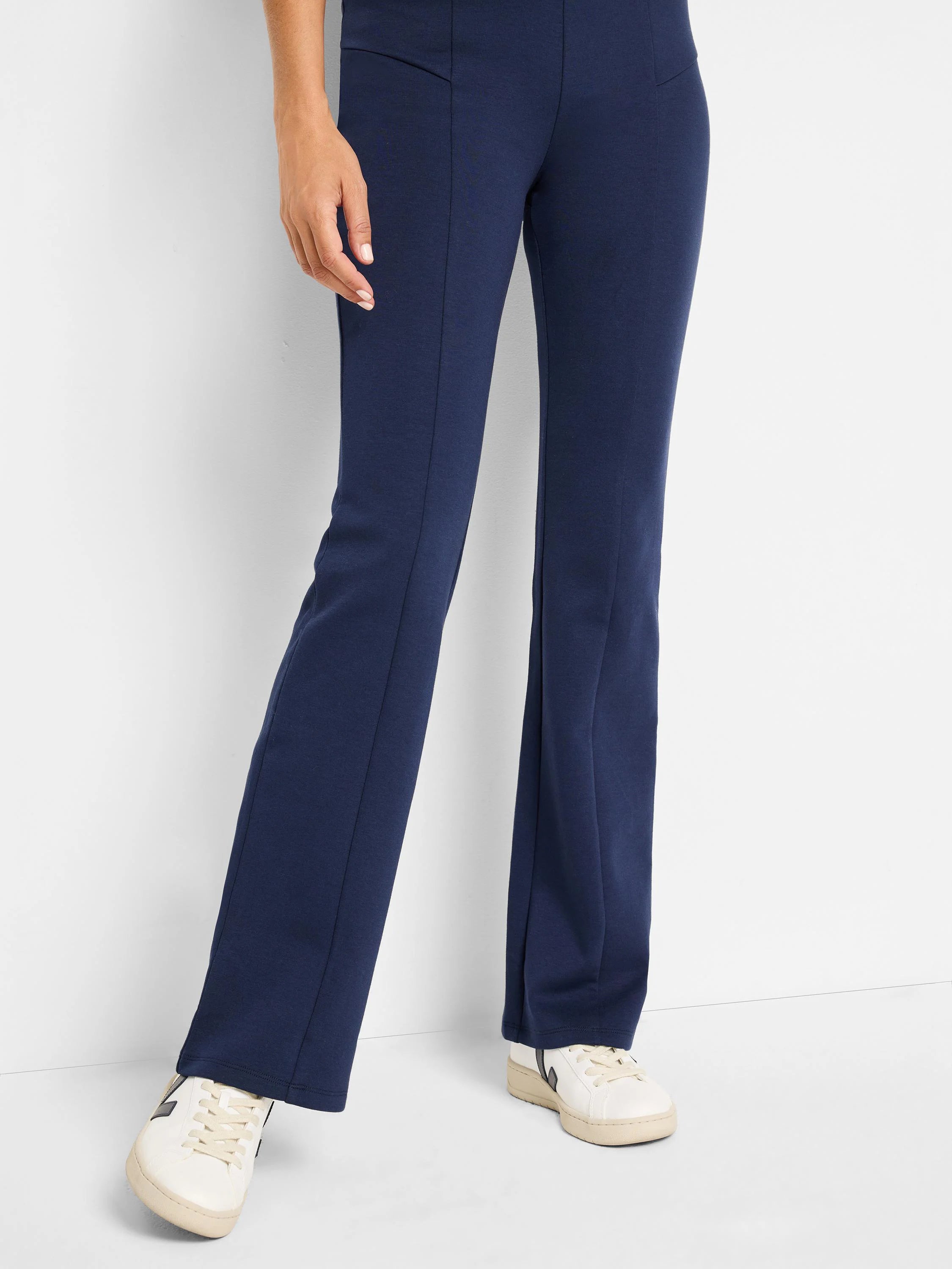 Navy blue bootcut pants with center seams; shown on a model.