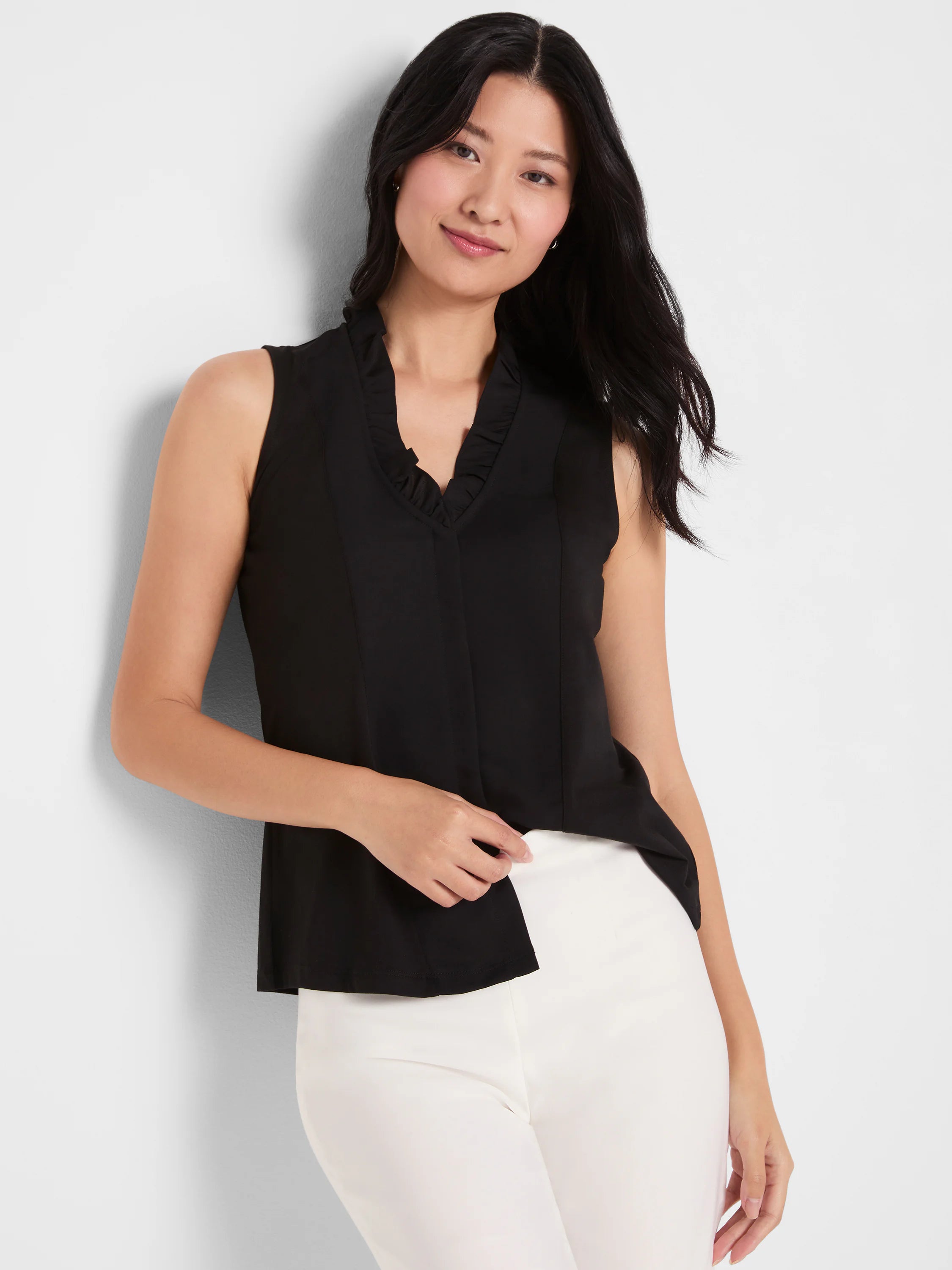 Black sleeveless tank with a ruffled V-neckline.