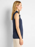 Navy blue sleeveless tank with a high, ruffled neckline.