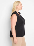 Black sleeveless tank top with ruffled mock neck.