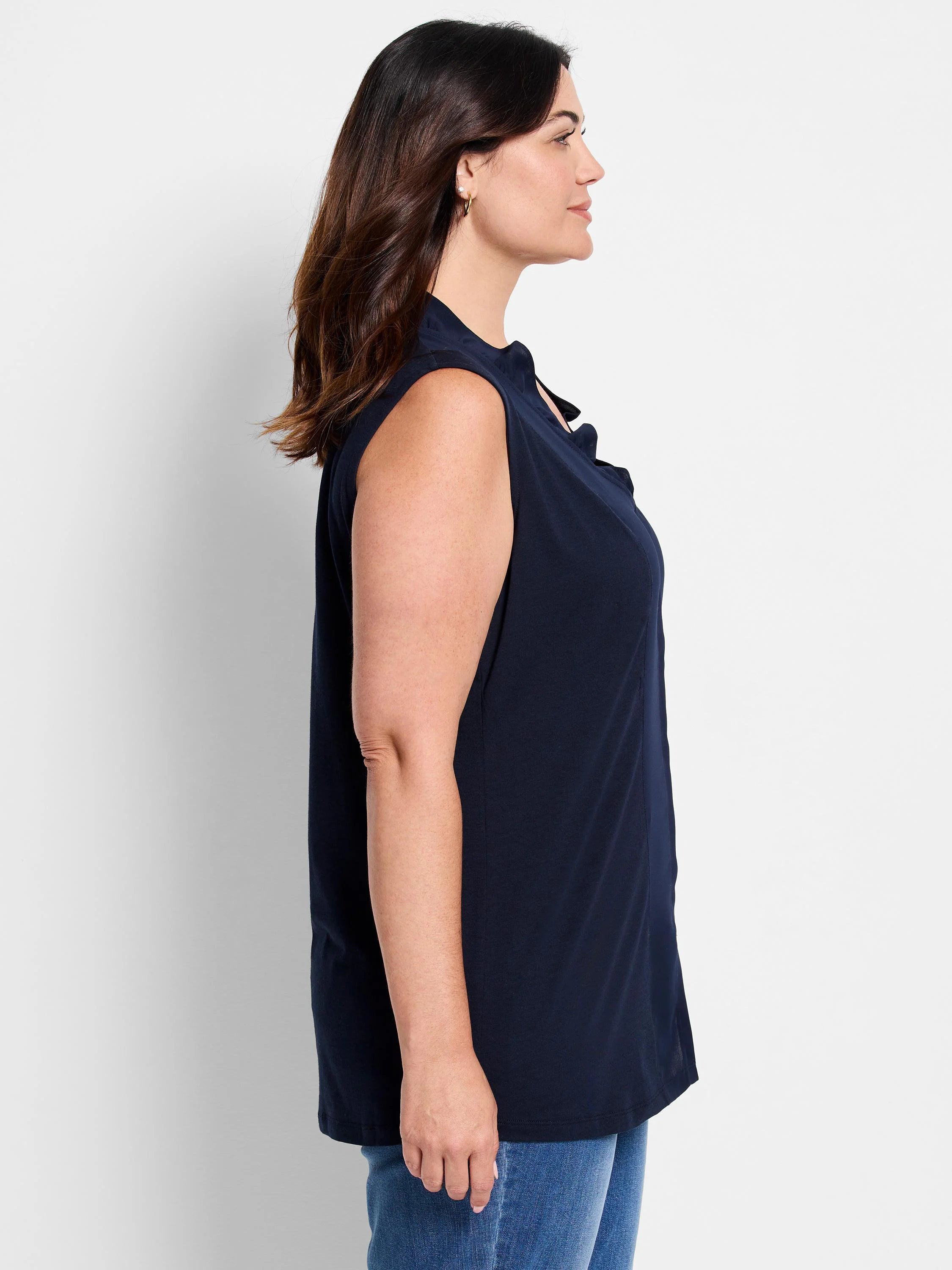Navy sleeveless tank with soft ruffles around the mock neck.