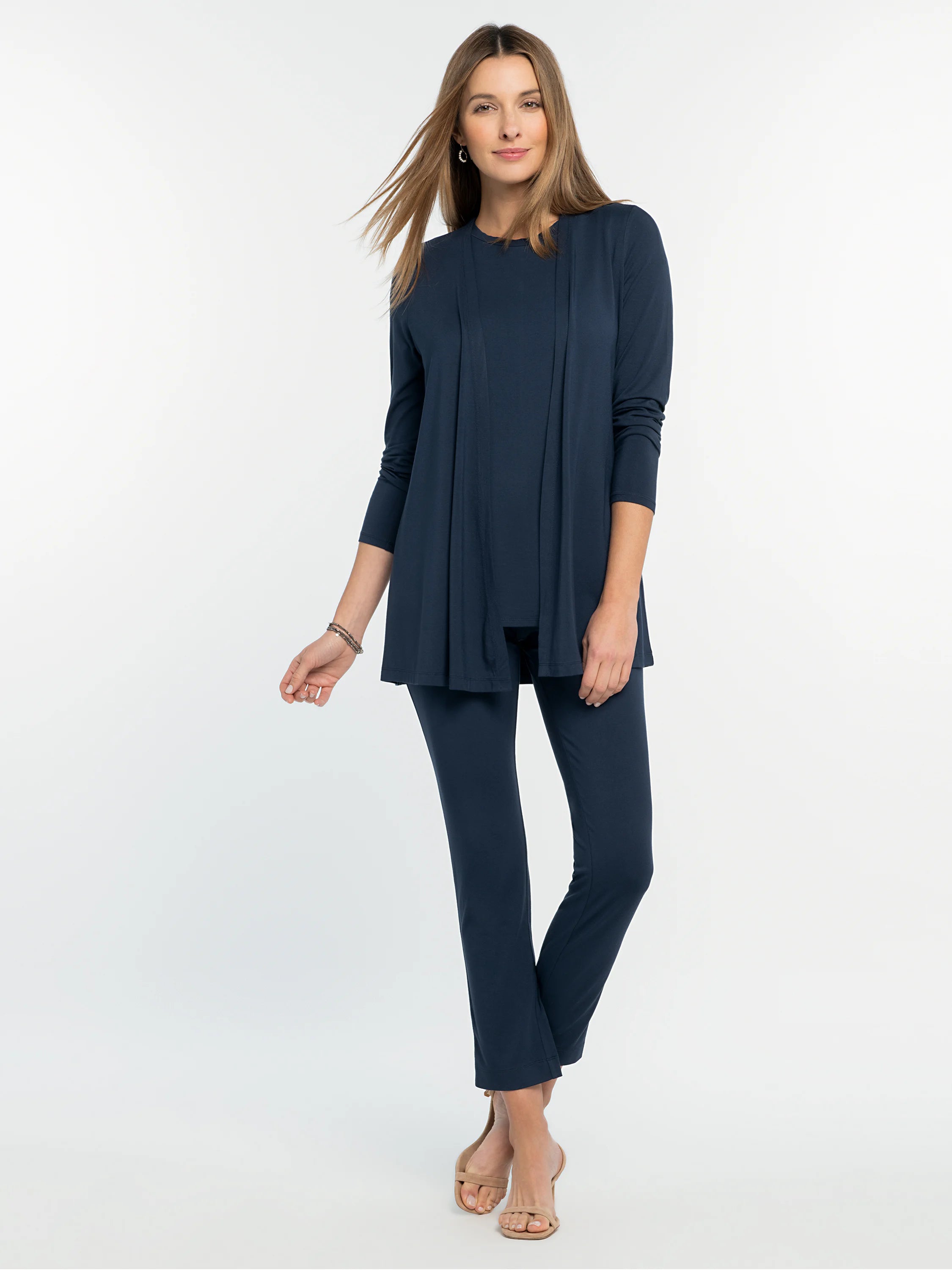 Navy blue long-sleeved crew neck tee, worn under an open matching cardigan; full outfit is navy blue.