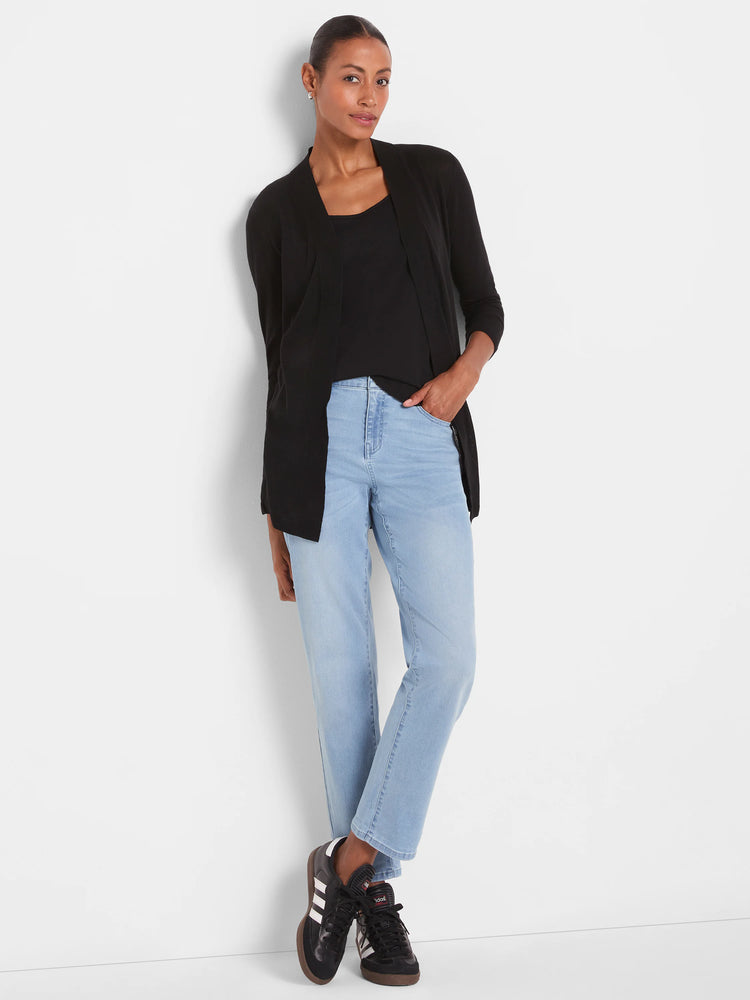 Black scoop neck tank top with a shirt tail hem, worn under a black cardigan.